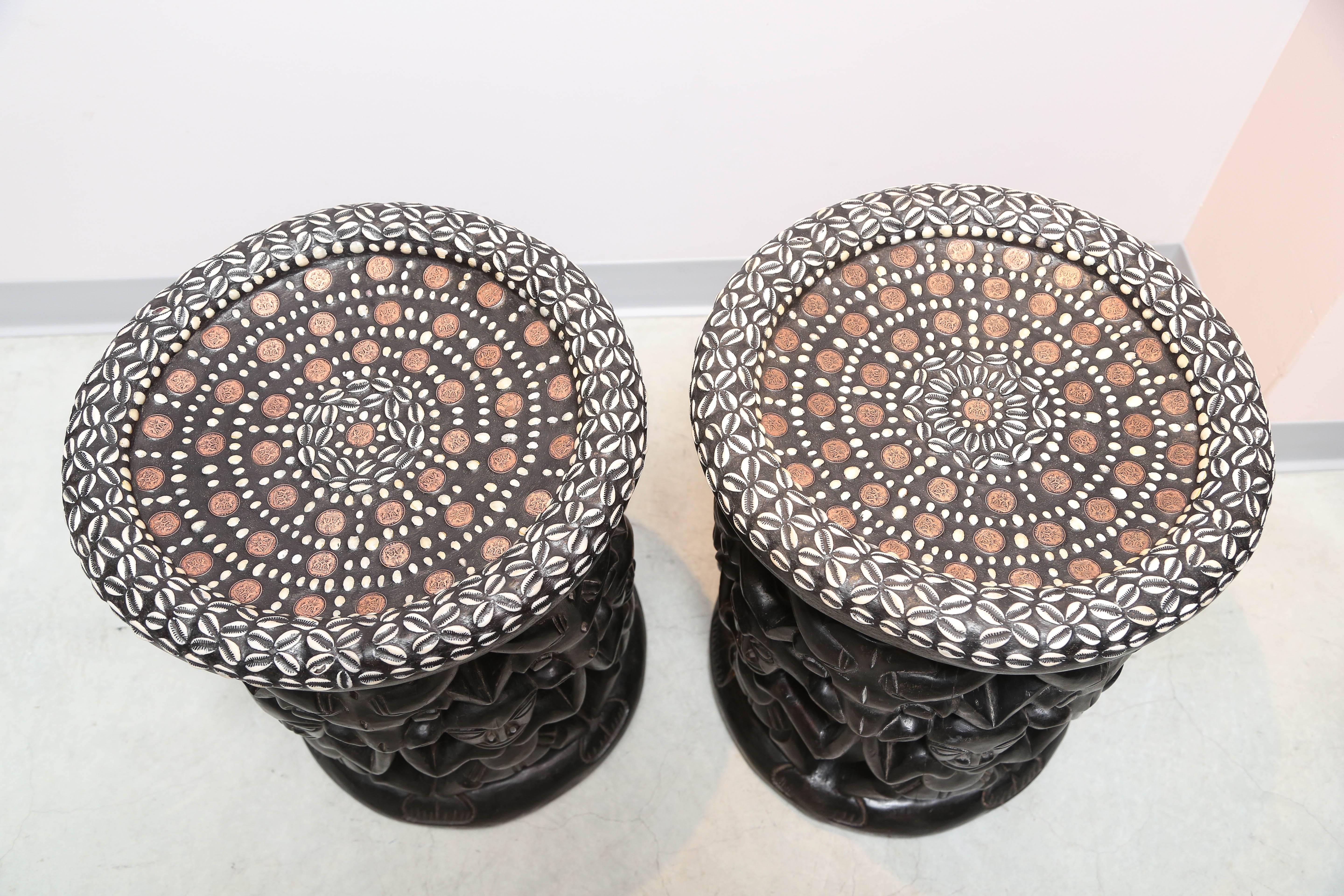 Contemporary Pair of African Side Tables Extensive Woodcarving Top Inlaid Coins, Cowry Shells For Sale