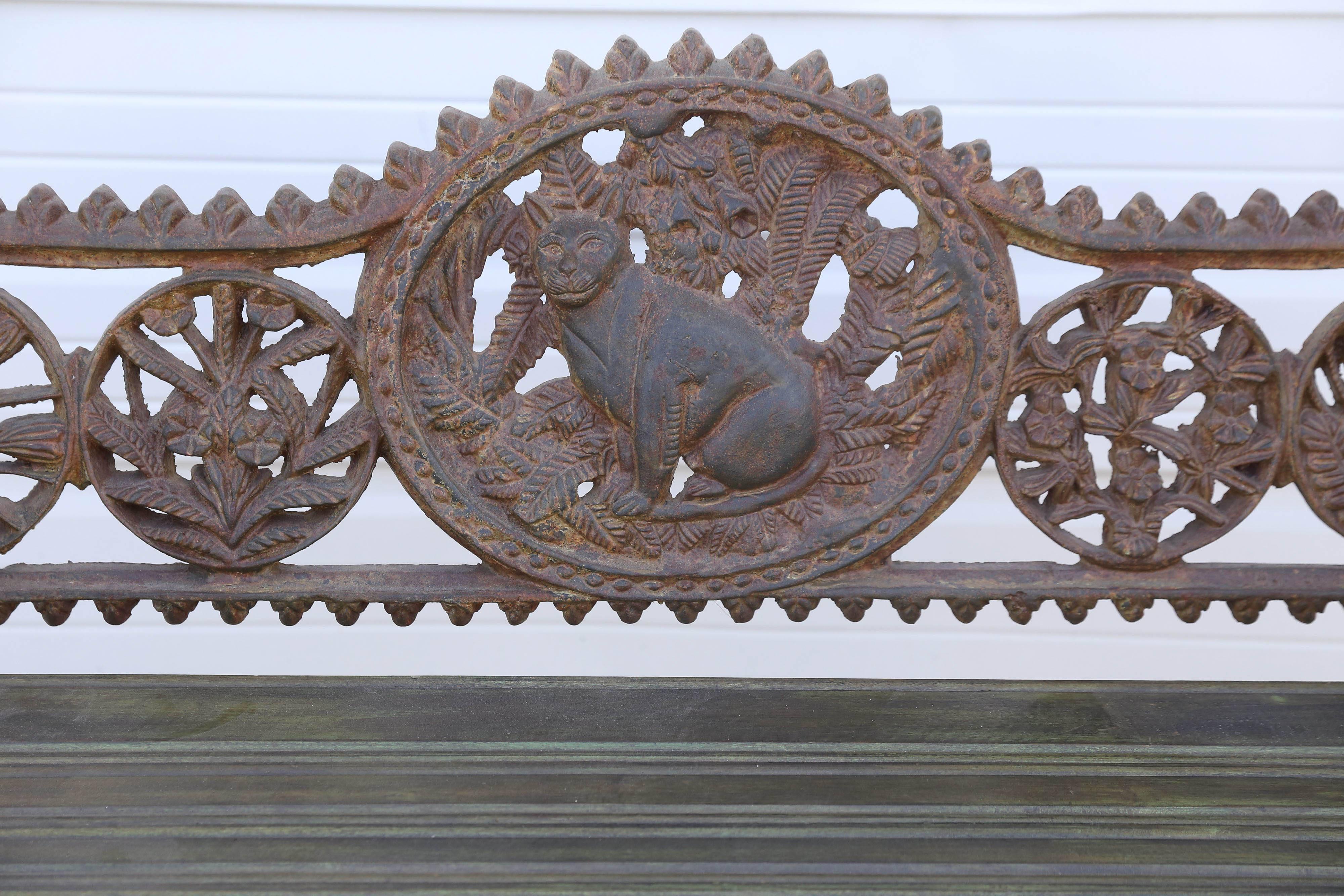 Benches like these were cast in old foundries in Calcutta and were extensively used in colonial rail road stations. The wooden seats would be replaced when the seats were worn out. This one has a cat emblem. These benches can be used in outdoor