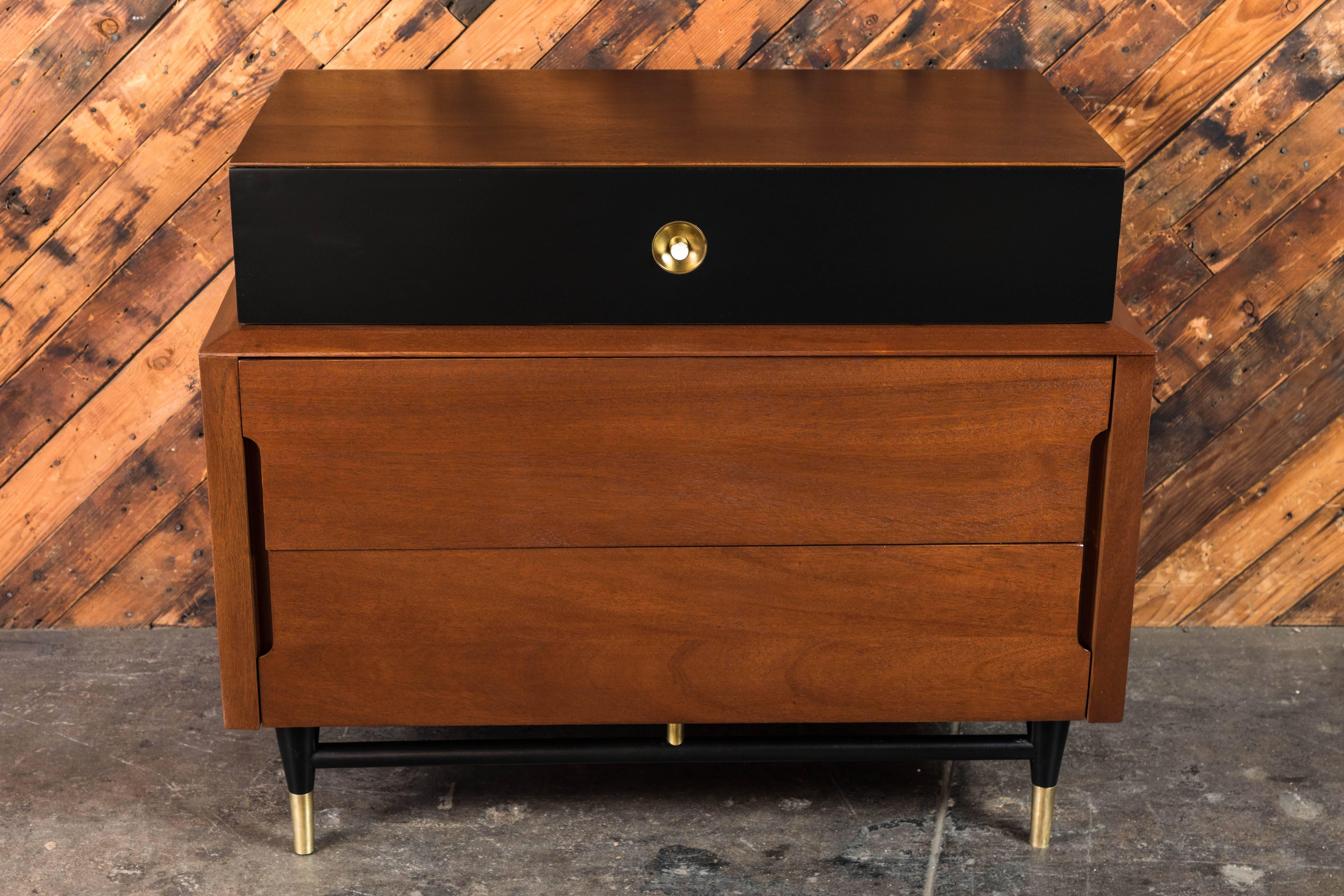 Fabulous pair of midcentury refinished walnut and lacquered small dressers with polished brass details. Can be used as oversized nightstands or compact but spacious two-drawer dressers.