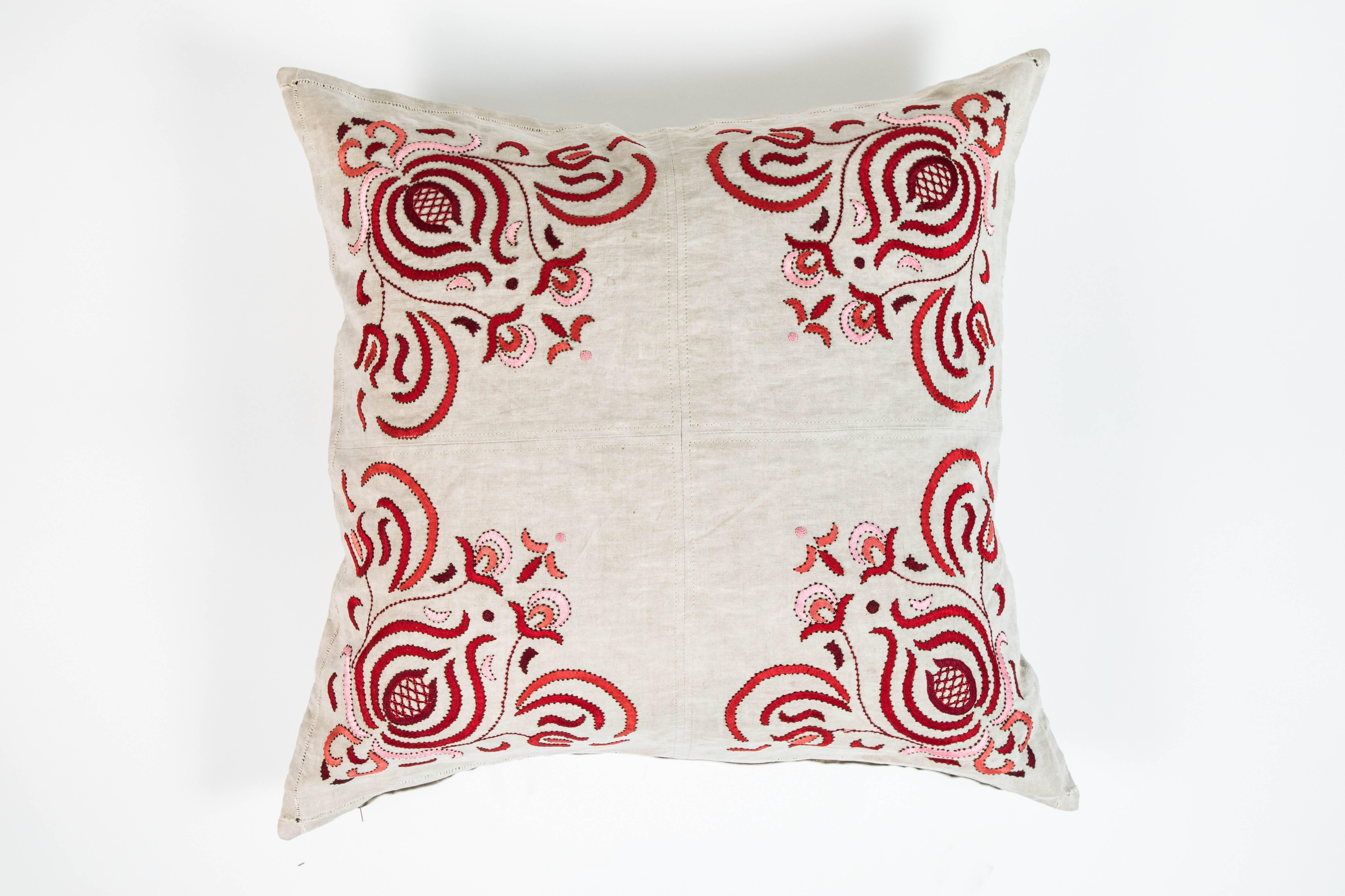 Custom pillow made from the four corners of a linen table cloth with red/pink embroidery and down insert. Measure: 26 x 26.