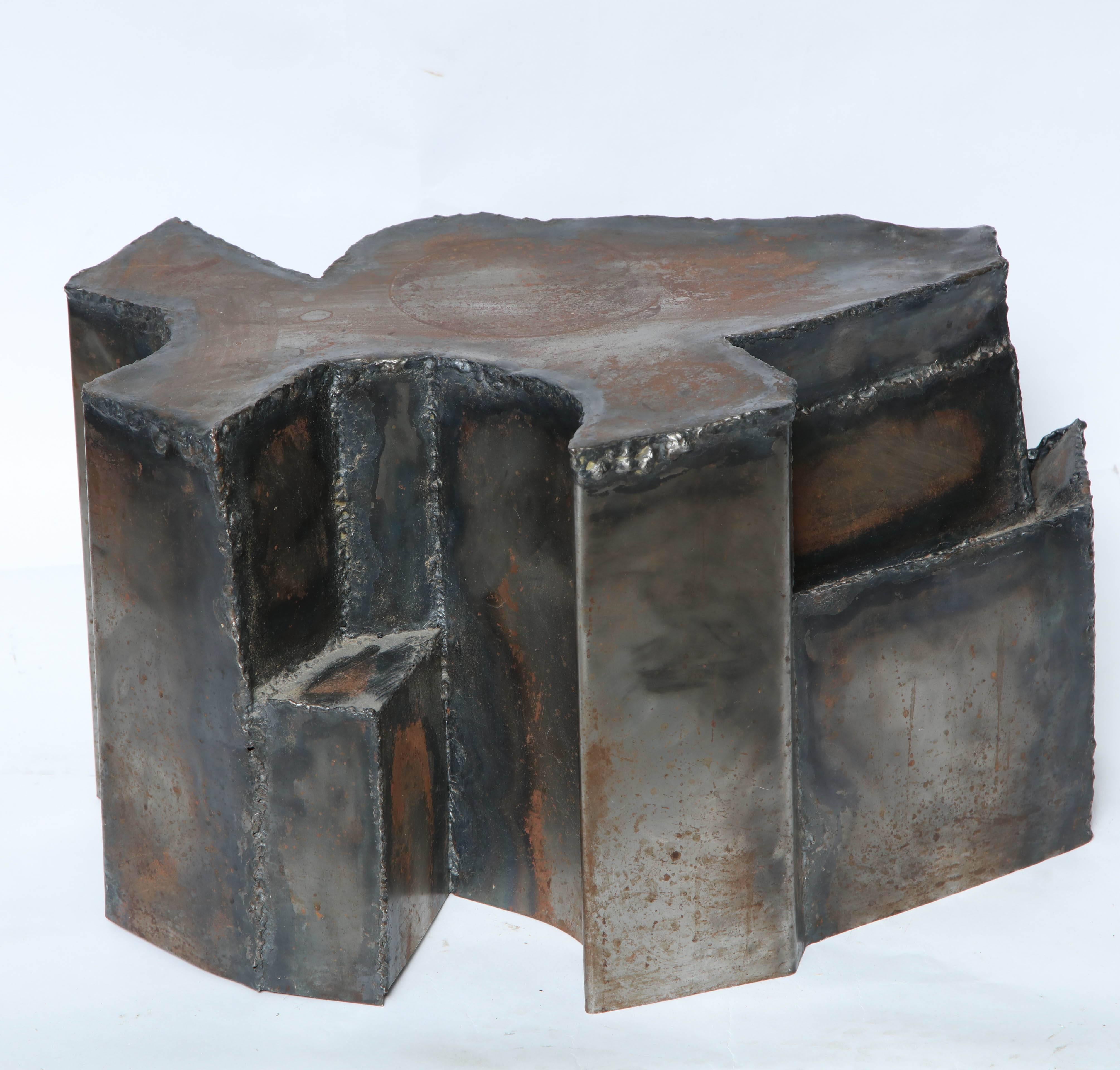 A Brutalist Mid-Century Modern sculptural handcrafted patinated metal end table.