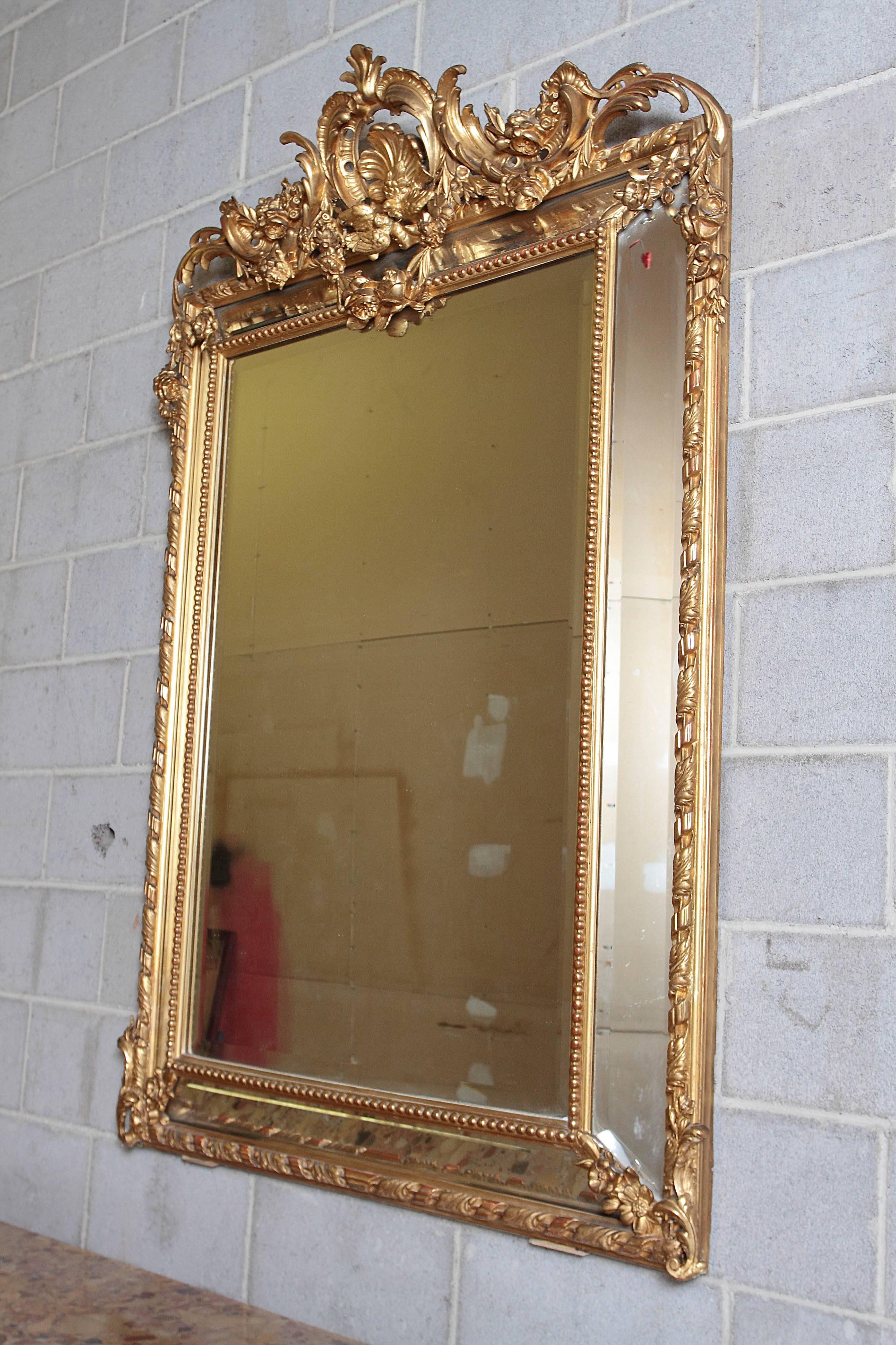 19th century French Louis XV gilt carved mirror. Fine detail with shell design at the top and doves kissing.