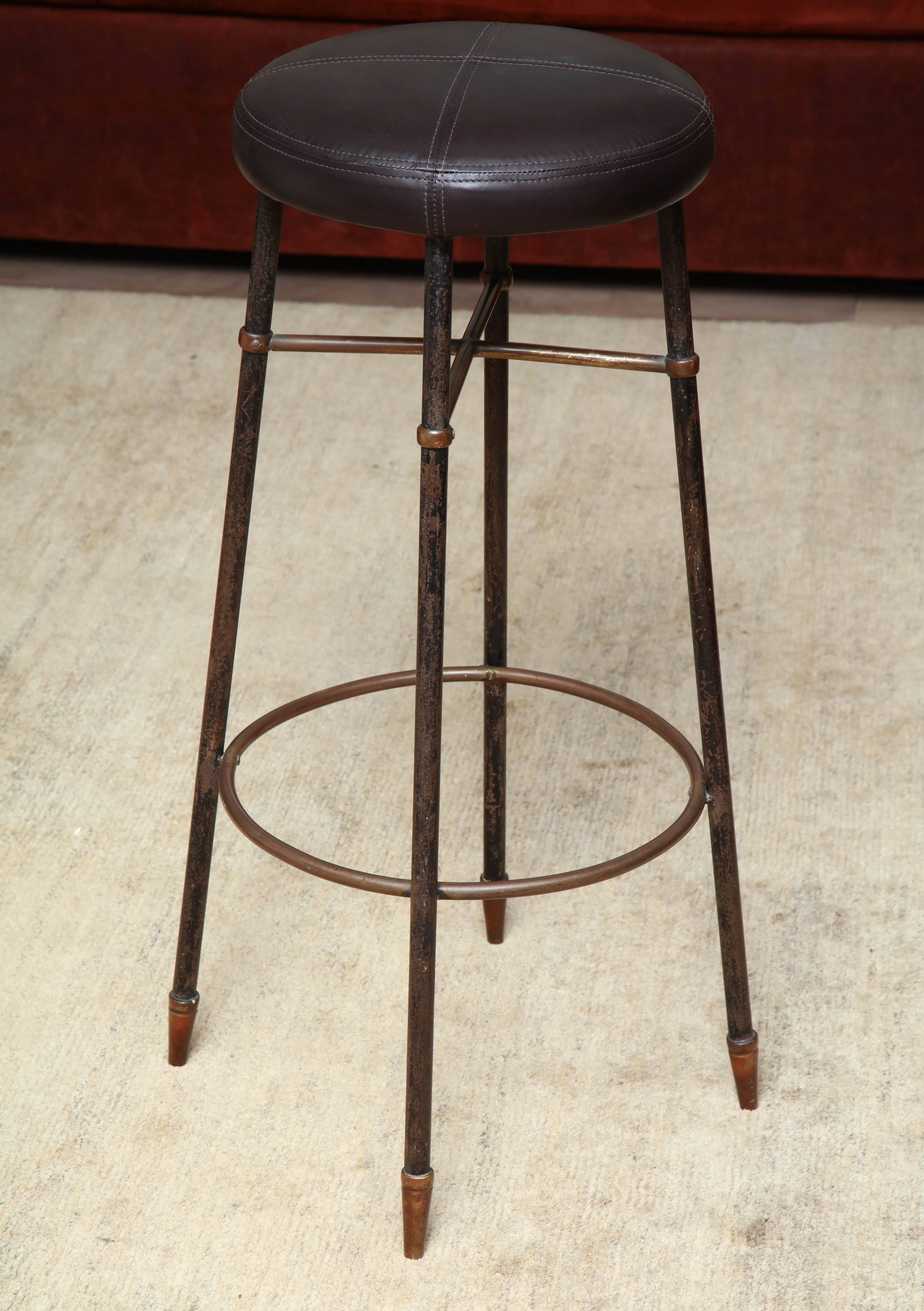 Pair of Italian barstools with original patina, circa 1950 reupholstered in brown leather with saddle stitch detail.
 