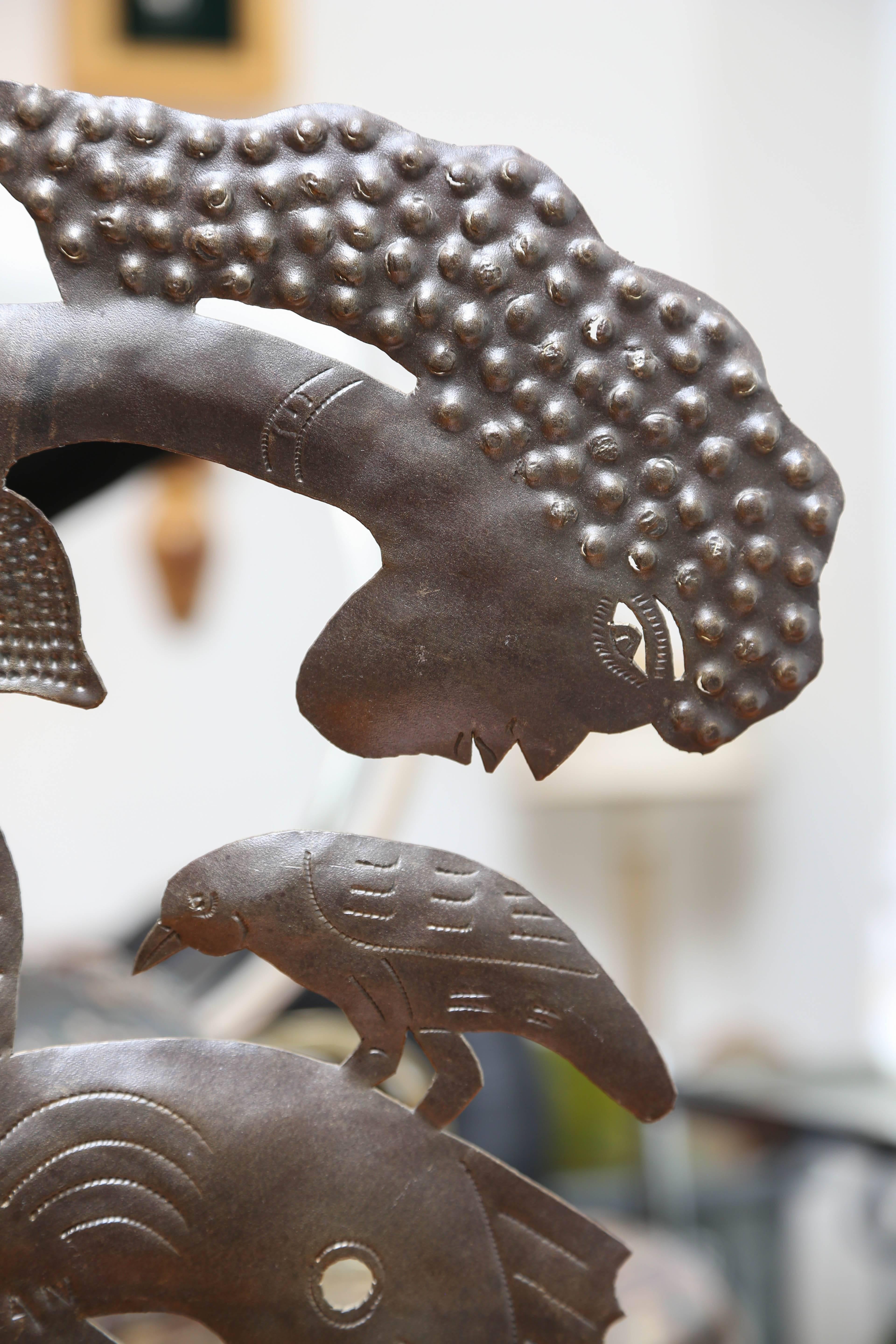 Metal folk art metal sculpture of Mermaid and bird by Haitian artist, Joel Balan. A free-standing piece on round metal base.