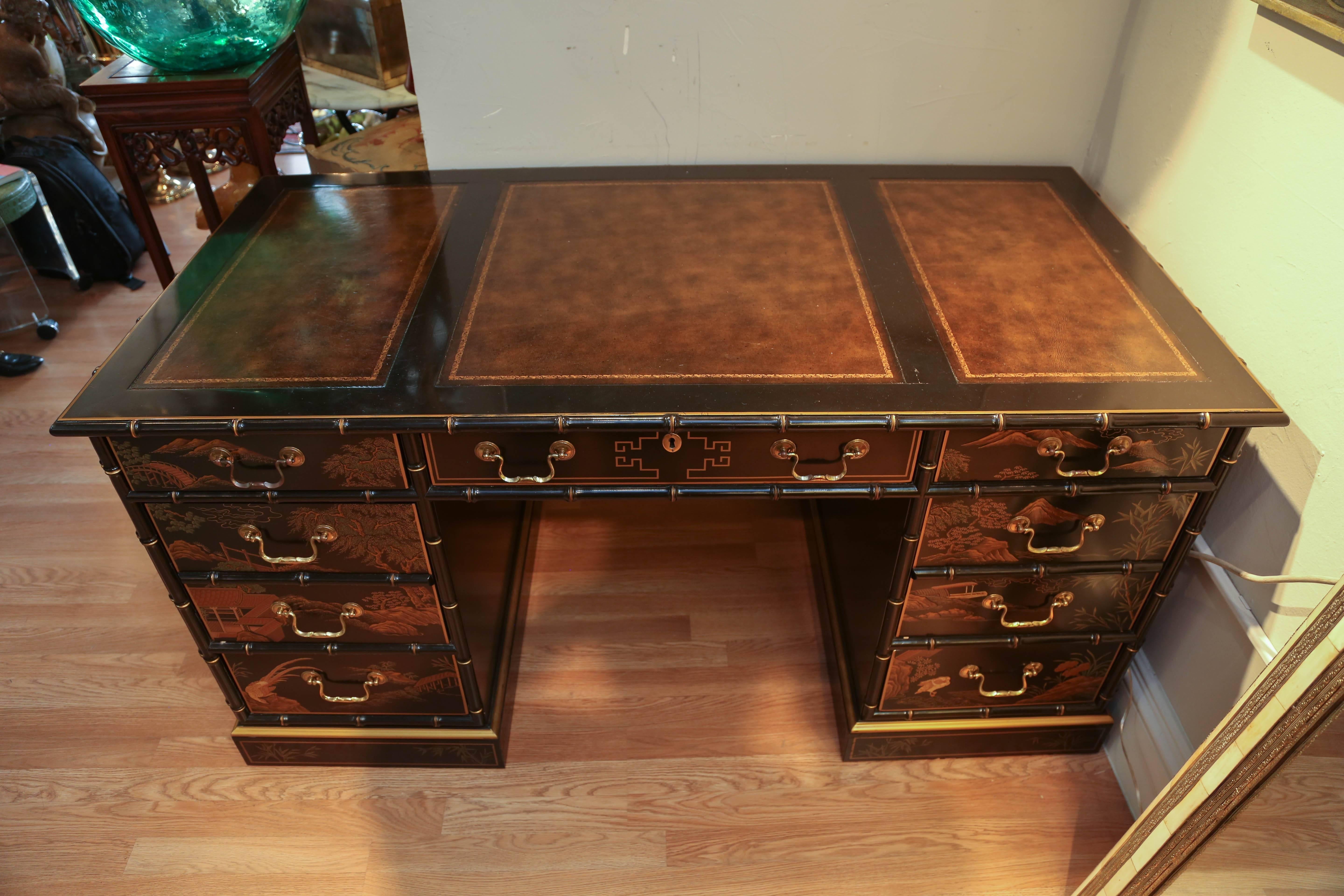 Black lacquered Chinoiserie partner's desk with brown leather embossed top. Drawers on front side only, but beautifully finished on all sides.
