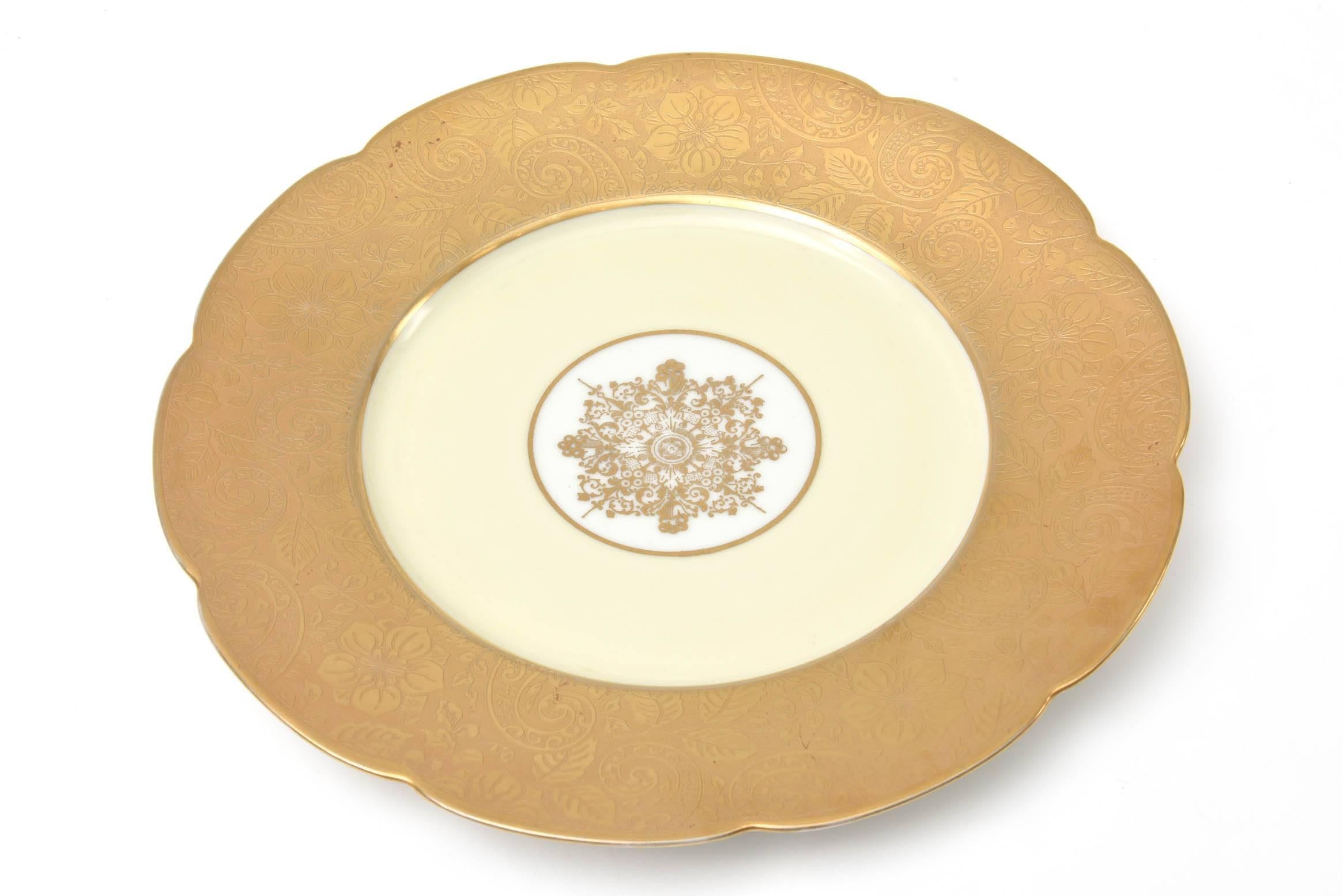 A very impressive set of 12 antique gilt encrusted presentation plates or charges featuring a nicely hand finished scallop shape and 24-karat gilt medallion. From the storied German firm of Heinrich who produced many custom table top pieces in the