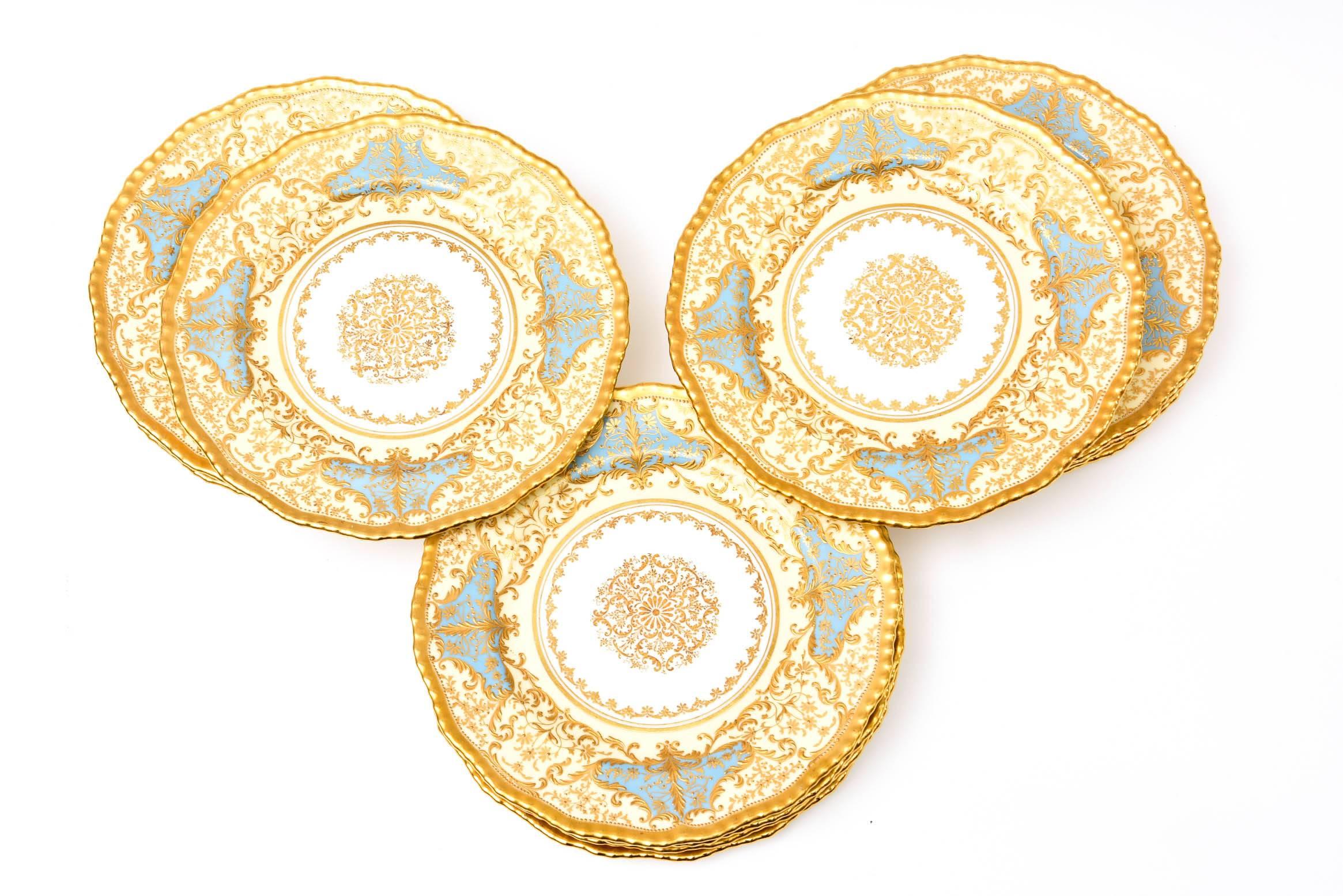 An exceptional set of vibrant plates by Royal Doulton, England. These antique plates, circa 1910 feature a turquoise almost cerulean colored cartouche in their collars. Surrounded by raised and hand tooled gilding, a shaped gadroon edge and a pretty