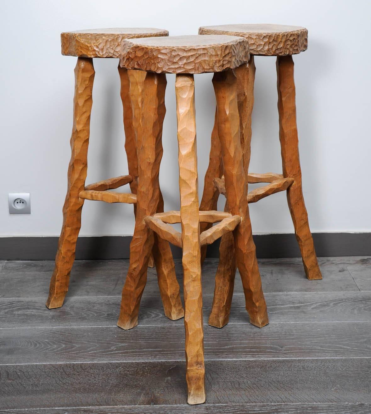 Set of three bar stools in solid oak with a hand scraped finish to the top.
In style of Atelier Marolles by Jean Touret, circa 1950.