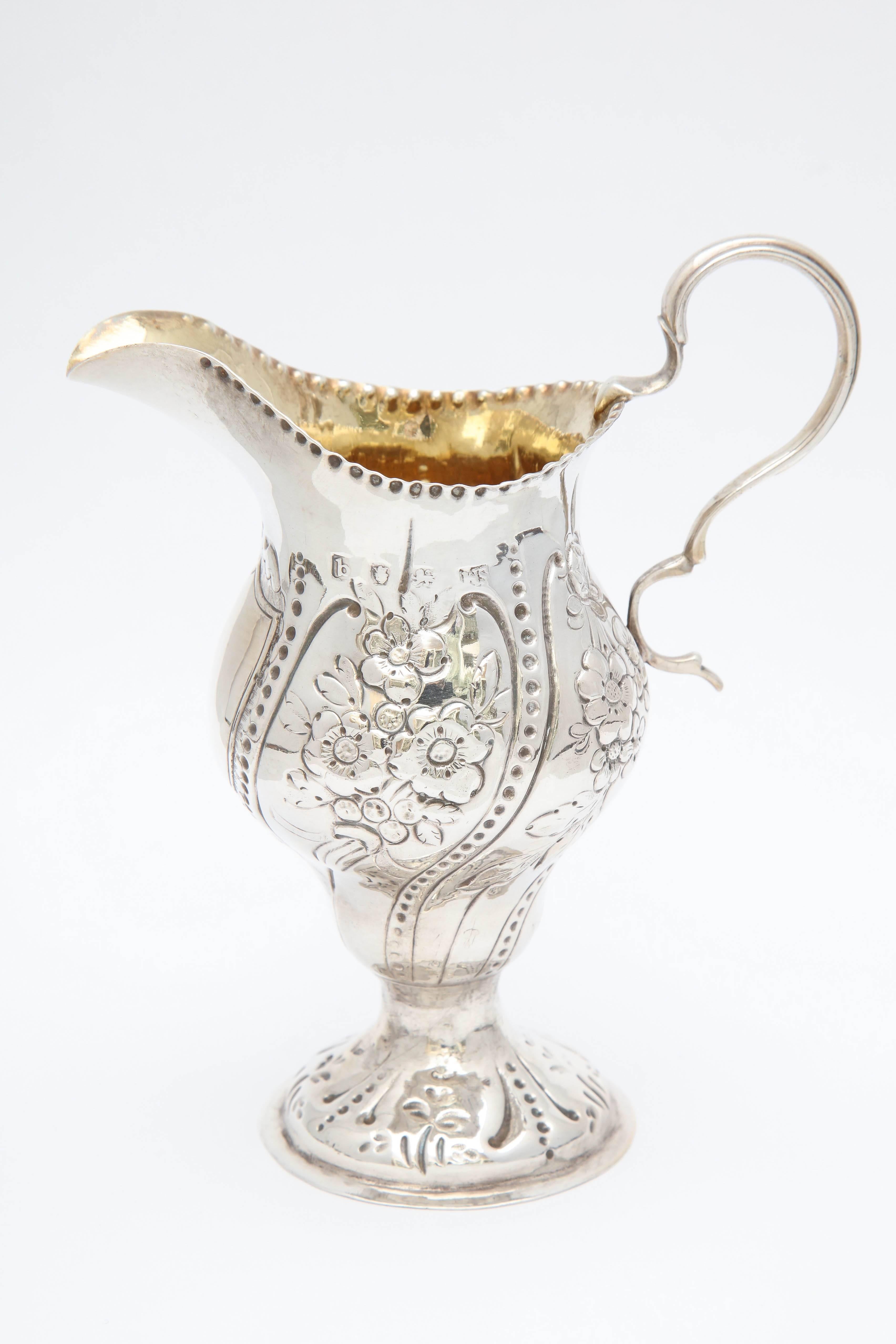George III, sterling silver cream jug or pitcher, London, 1777, William Sudell - maker. 5 1/2 inches high at highest point x 2 1/2 inches diameter (at widest point) 2 3/4 inches across from handle to spout; base is 2 1/4 inches in diameter. Weighs