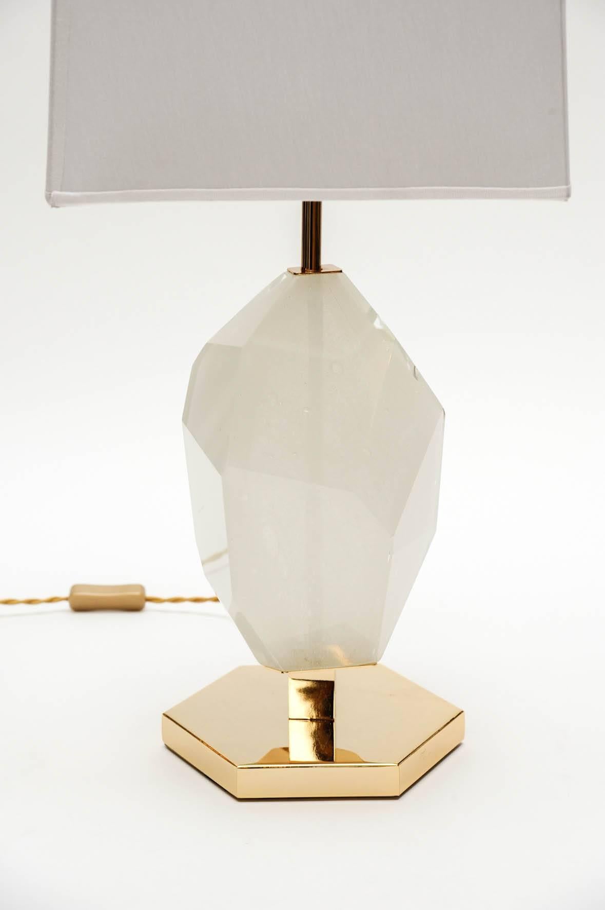 Decorative and elegant pair of table lamps made of a brass hexagonal foot and structure, and a centerpiece of slightly transparent and white resin.

The brass has been nickeled then slightly gold finished, which gives the lamp an unique color
