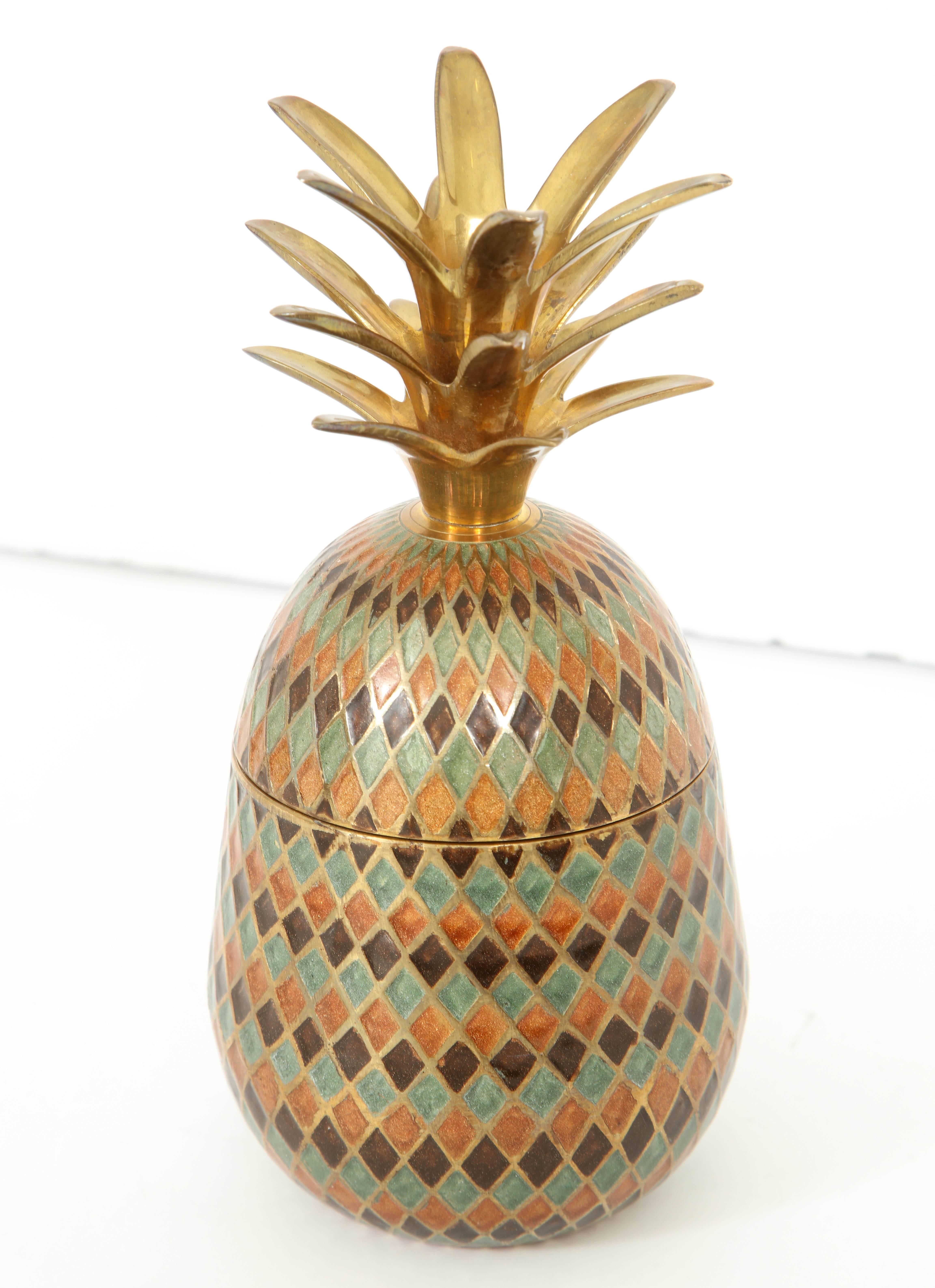 Pineapple ice bucket with a beautifully decorated Cloisonne diamond pattern.
The interior of the pineapple is polished brass and holds a single bottle.