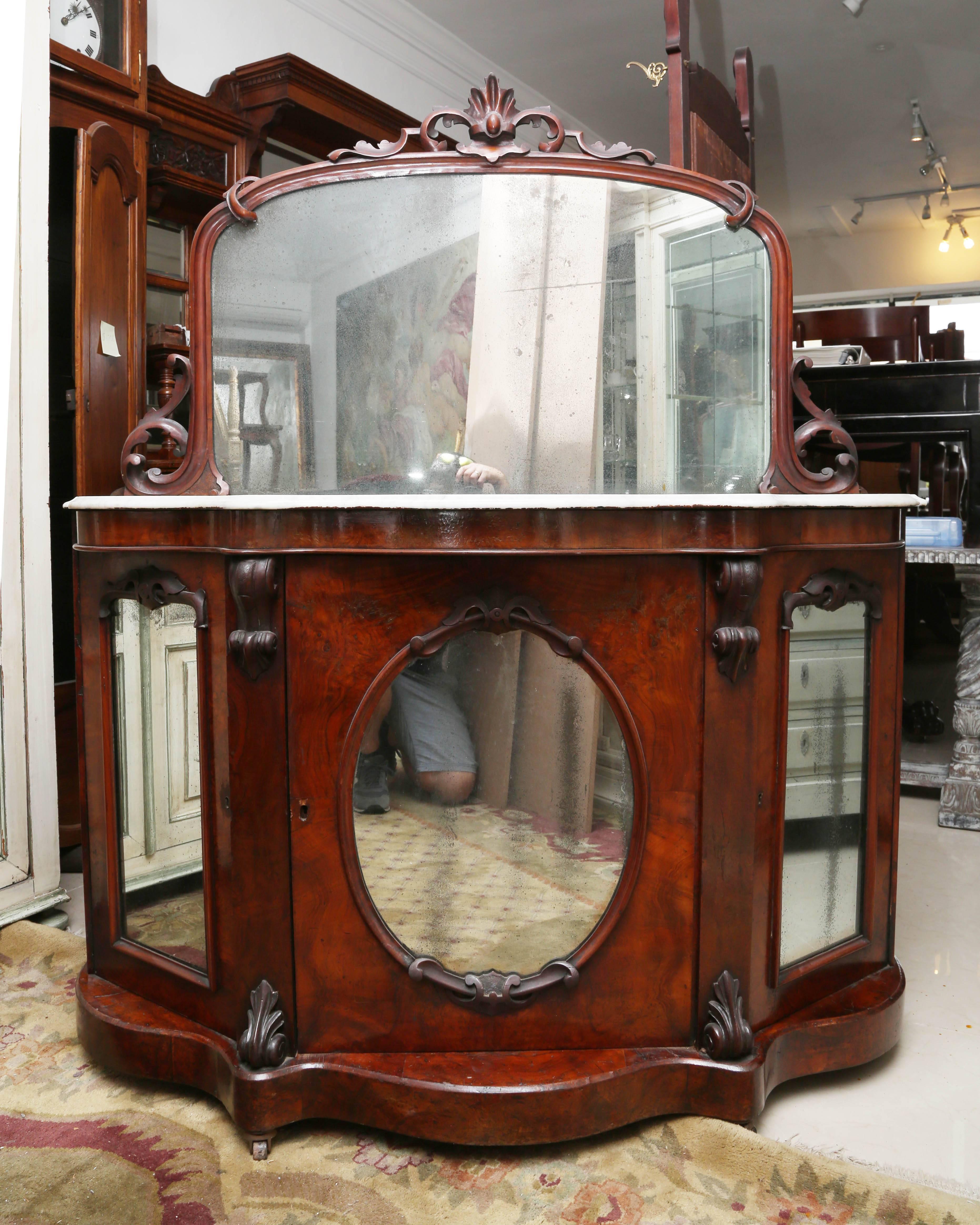 This is a very nice marble top English server which could be used as a bar, console or server.
It burr walnut Victorian with a marble top.
It has the original marble and original patina, all the mirrors are frosted with age.
This would have been