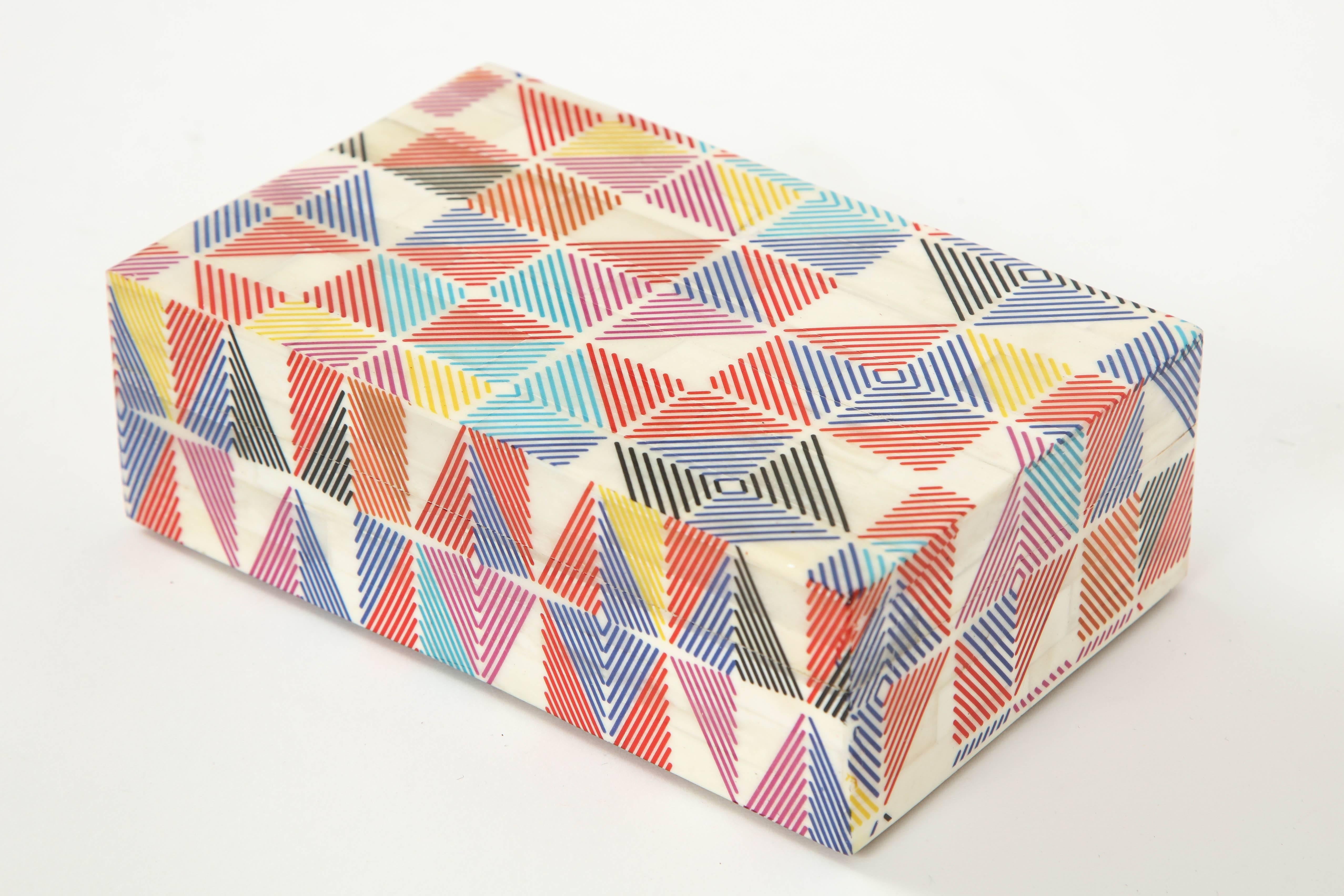 Colorful keepsake box with dyed bone panels with hand incised details lined in zebra wood.