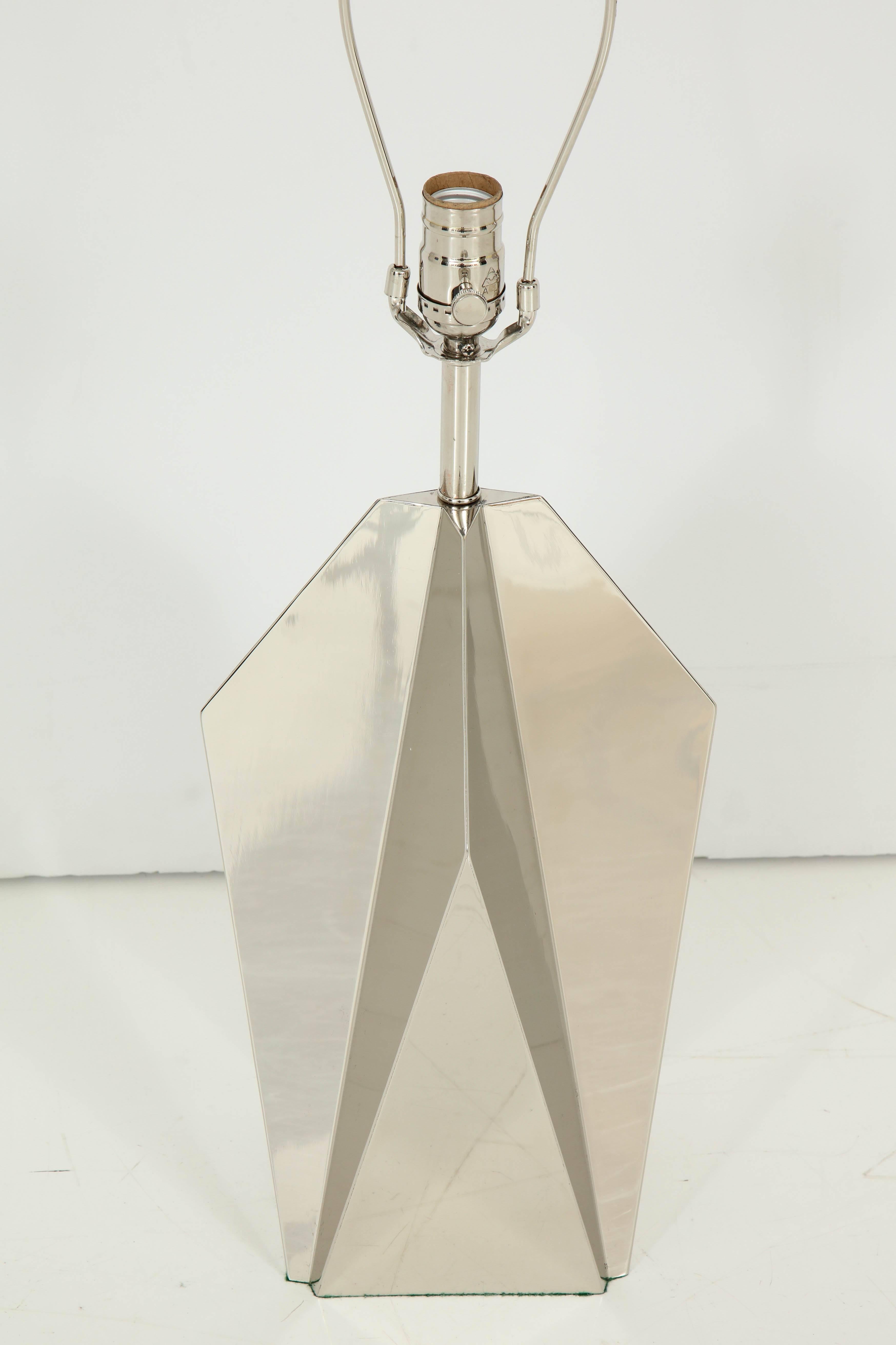 Pair of architectural polished nickel lamps in a stylized star form composed of geometric panels. These showcase the 1970s movement of Art Deco meets 70s cool. Rewired for use in the USA. 100W max bulbs.