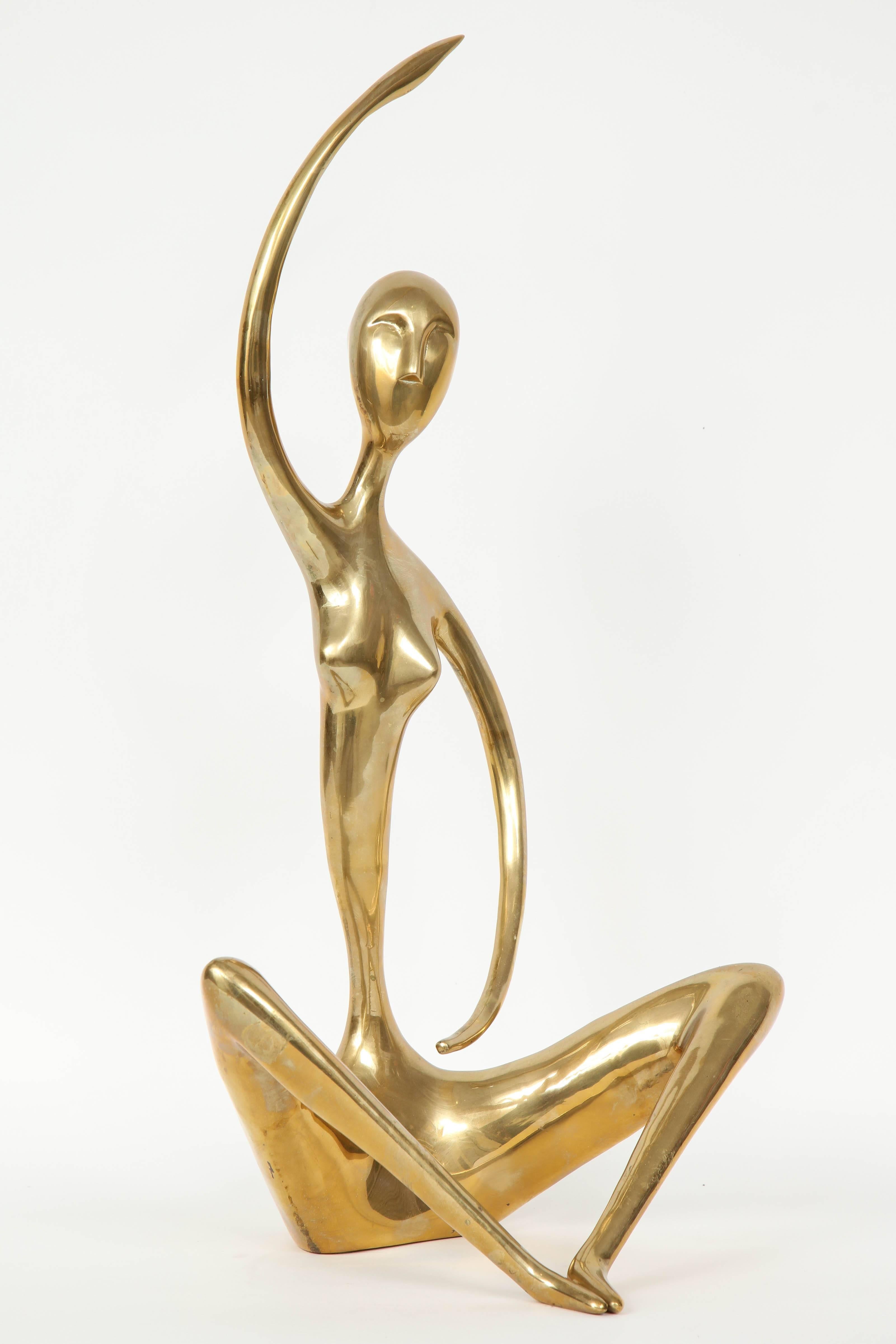 Modernist brass sculpture of seated figure holding a yoga pose. Brass has a great aged patina. Jaru.
