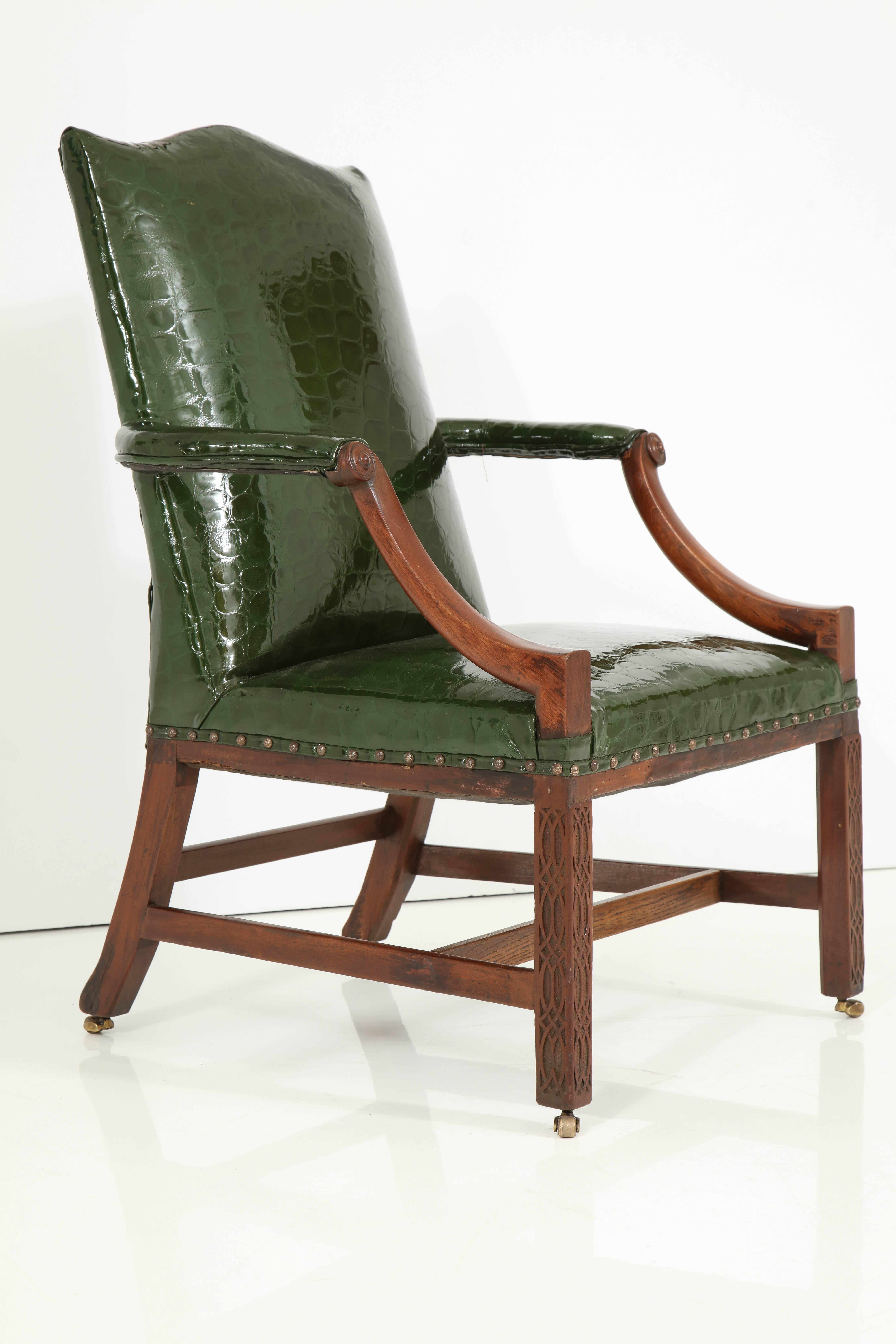Old meets new in this handsome English mahogany armchair. Beautifully crafted, this comfortable chair features lovely, but subtle details including gracious, slightly curved arms with small carved design at end of armrest and reticulated carving on