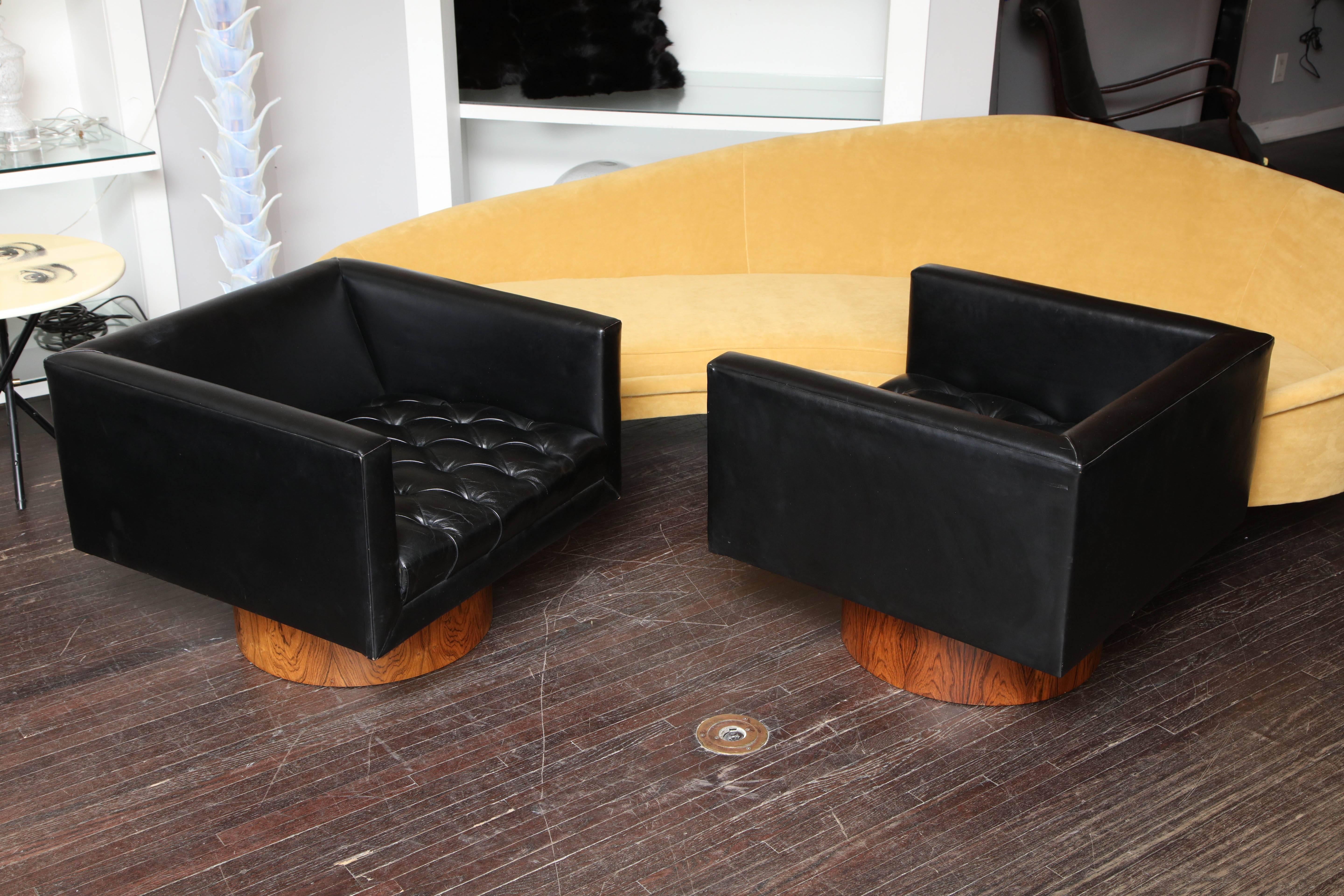 Harvey Probber swivel chairs with walnut base with black shearling back cushions.