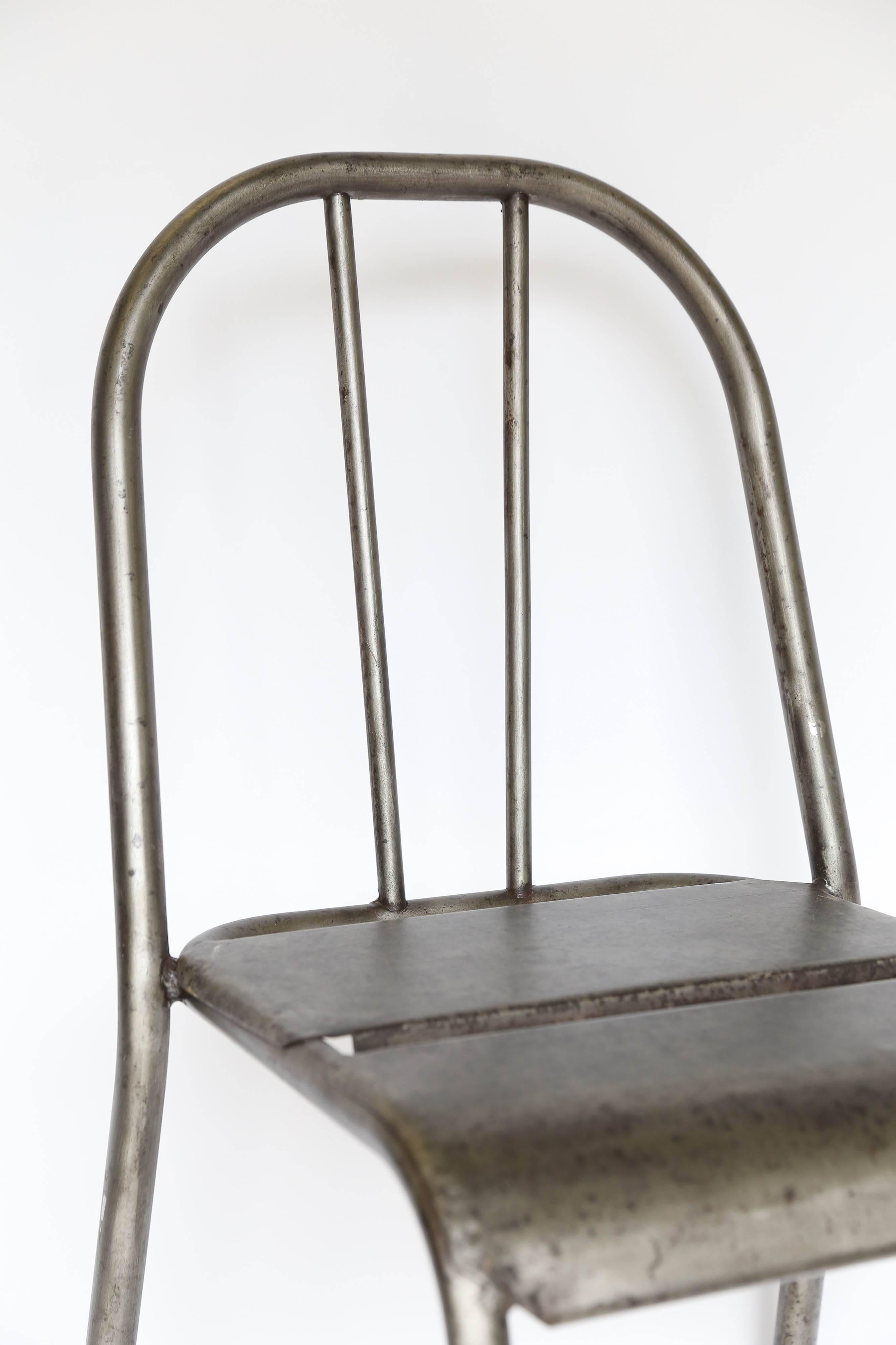 Found in France, a metal side chair with an Industrial flair. Substantial weight, a wonderful patina and sculptural lines give it style while the waterfall edge on the front of the seat makes this an unusually comfortable chair. Five are available.