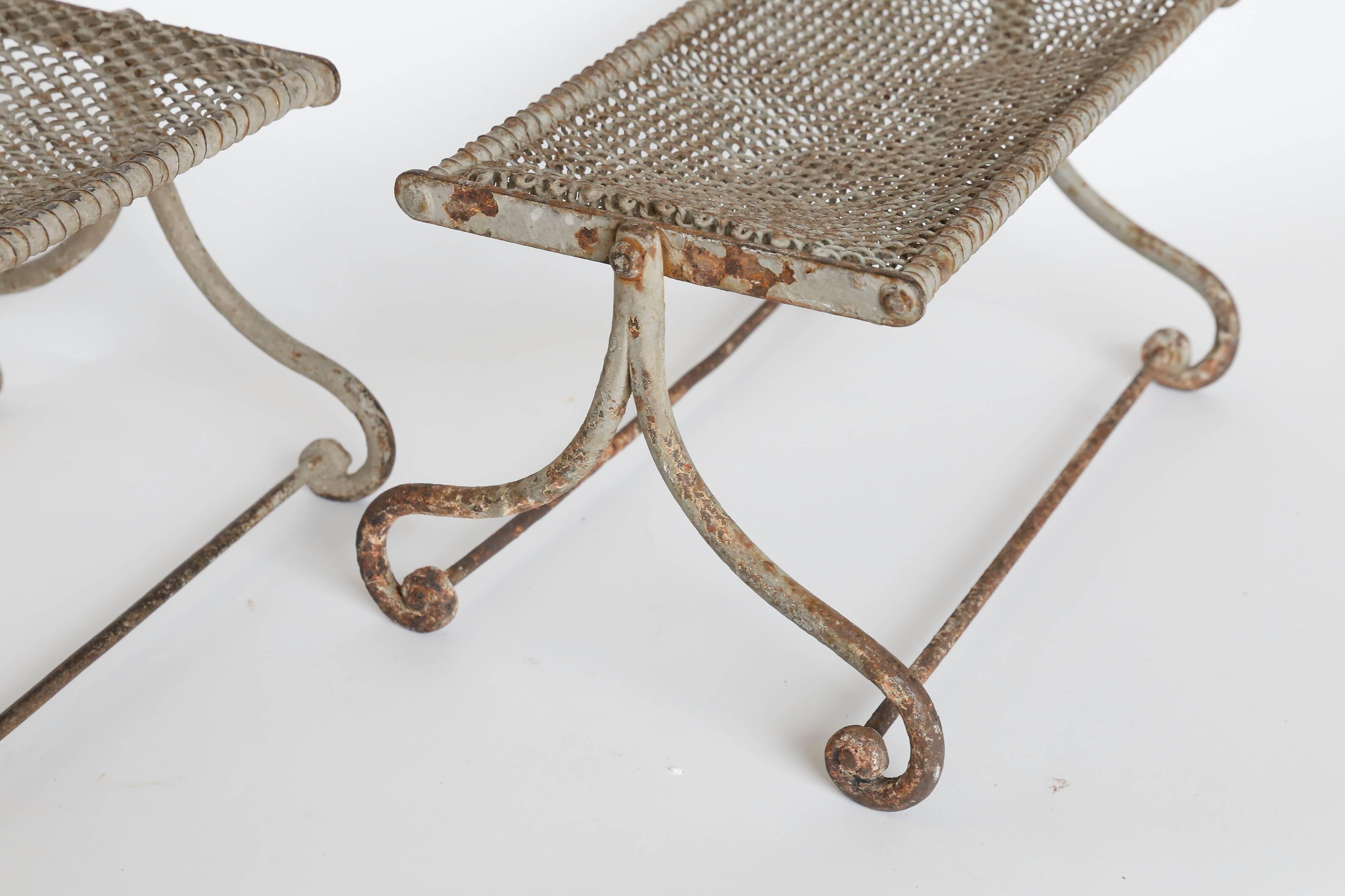 Unique metal footrest found in France. The sturdy iron frame has curled feet with stretchers. The swivelling top frame has heavy gauge iron mesh. The original grey paint has worn and aged to a wonderful patina.
Two are available and are sold
