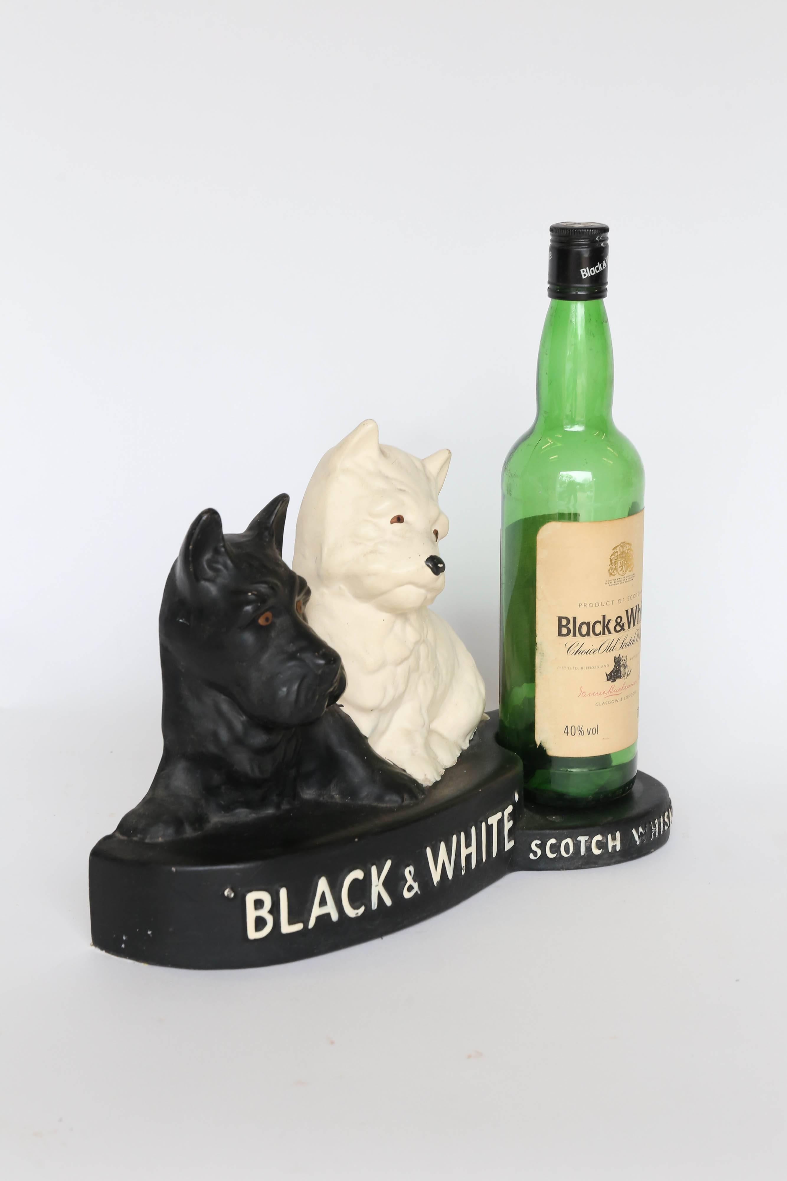 Black and white Whisky brand's motif featuring a black Scottish Terrier and a white West Highland White Terrier with a bottle was used in advertising the brand. This is a lovely collectable - for the lovers of both Scottie Dogs and West Highland