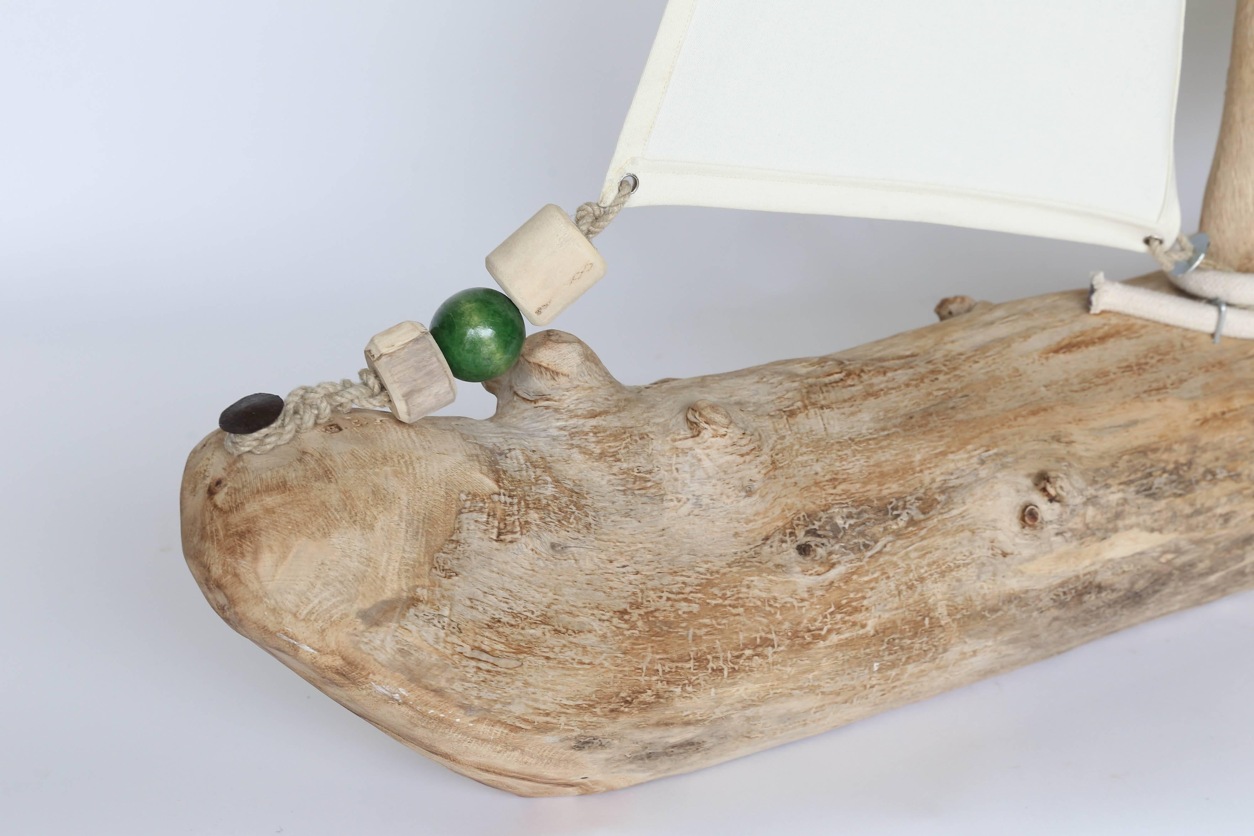 This sailboat is a creation from the Catalan region of Spain. The husband and wife team creates art that brings nature closer to your home in a decorative and functional way. The body of the boat is made from a piece of sea driftwood that was