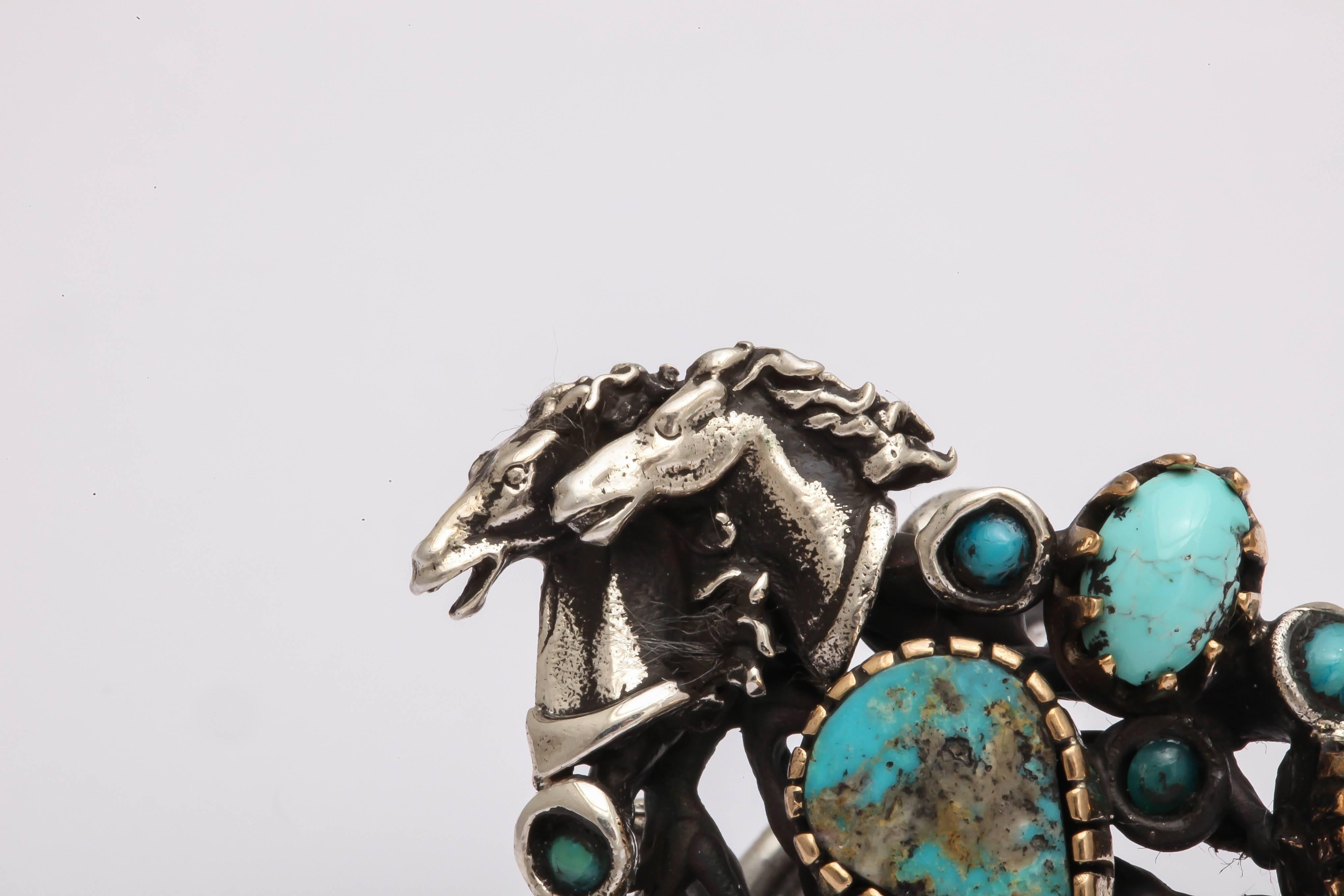 Great looking and impressive ring for the horse enthusiast. The shank is adjustable and is suitable for men or women. The turquoise stones are set in various styles to give the ring texture and interest. The silver is oxidized for a vintage look.