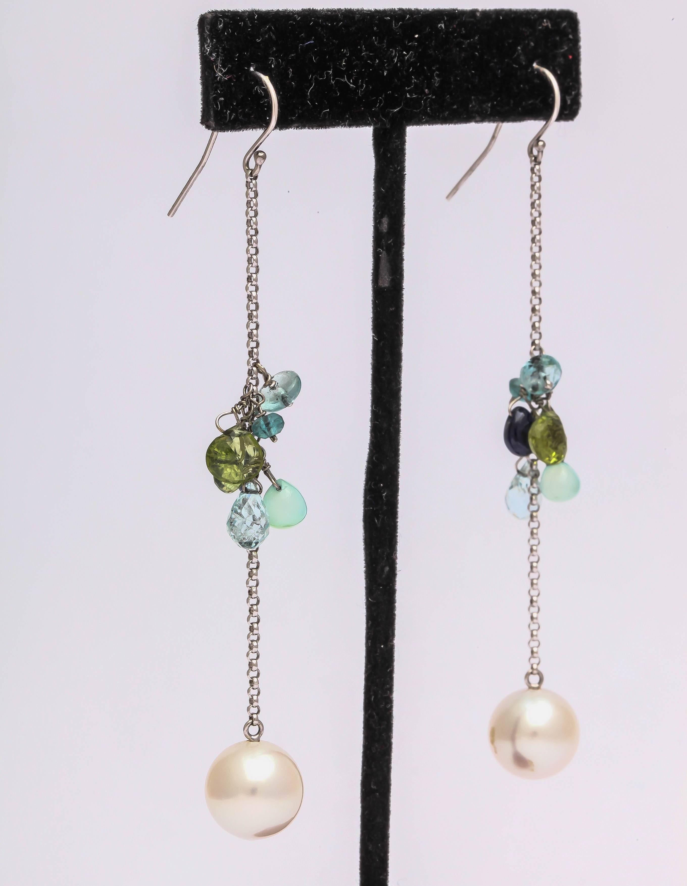 These are high fashion modern earrings. They are made in 14 kt white gold, South Sea pearl at the bottom of the chain with a mix of briolets and beads enhancing the center of the chain. The total length is 3 1/2 inches from the top of the ear hook