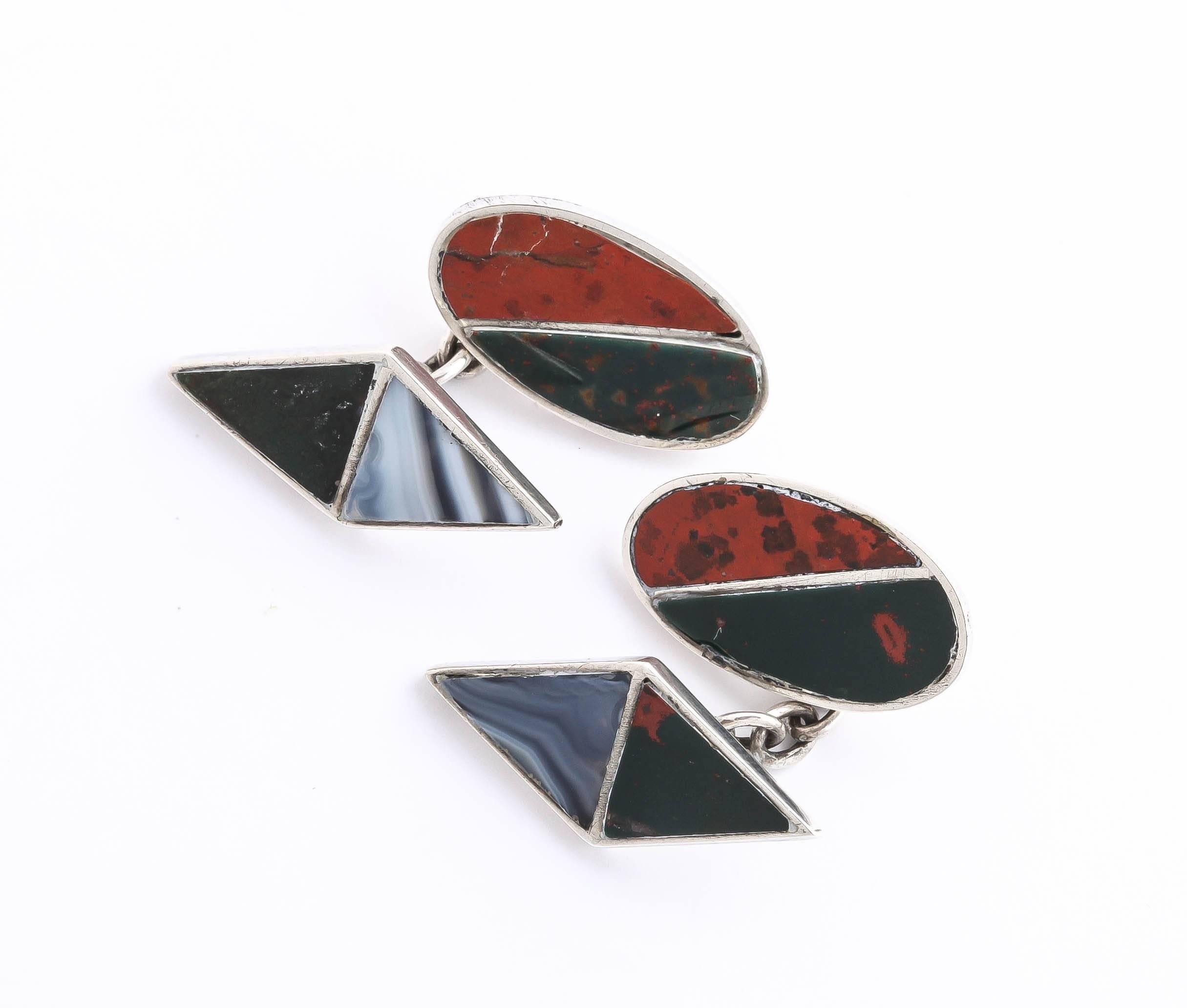 One side is oval inset with Jasper and Bloodstone and the other is a diamond shape inset with Chalcedonyx and Black Onyx.

Impressed for 925 silver/ Birmingham/ 1929/ J C & S.