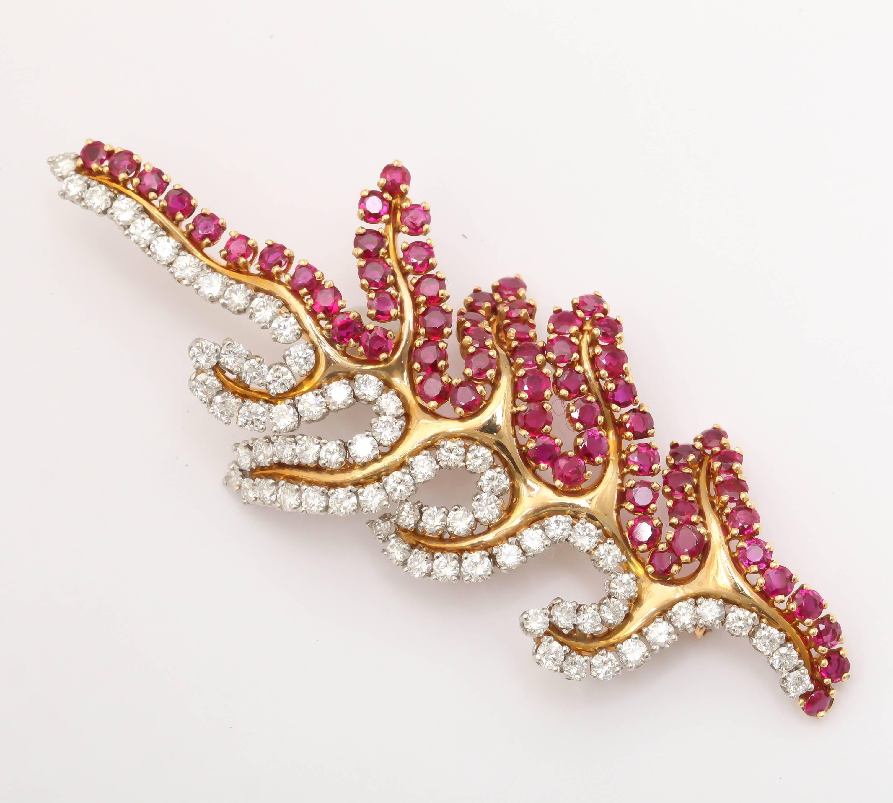 Sumptuous 18kt Yellow Gold Abstract Leaf Brooch set with genuine Rubies & super white clean cut Diamonds.  Numbered, but not signed.  Ca 1950-1960.
Everything about it screams quality & style. Certainly not a brooch to forget. 