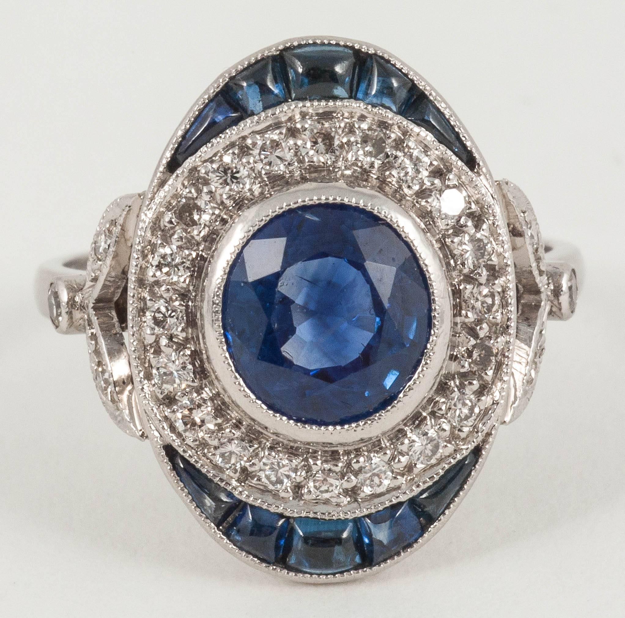 This stylish natural Ceylon Sapphire ring is surrounded by Diamonds and calibrated cabochon Sapphires at either end. The Sapphire is approx. 1  CT and there is no evidence of  enhancement

Ring size M