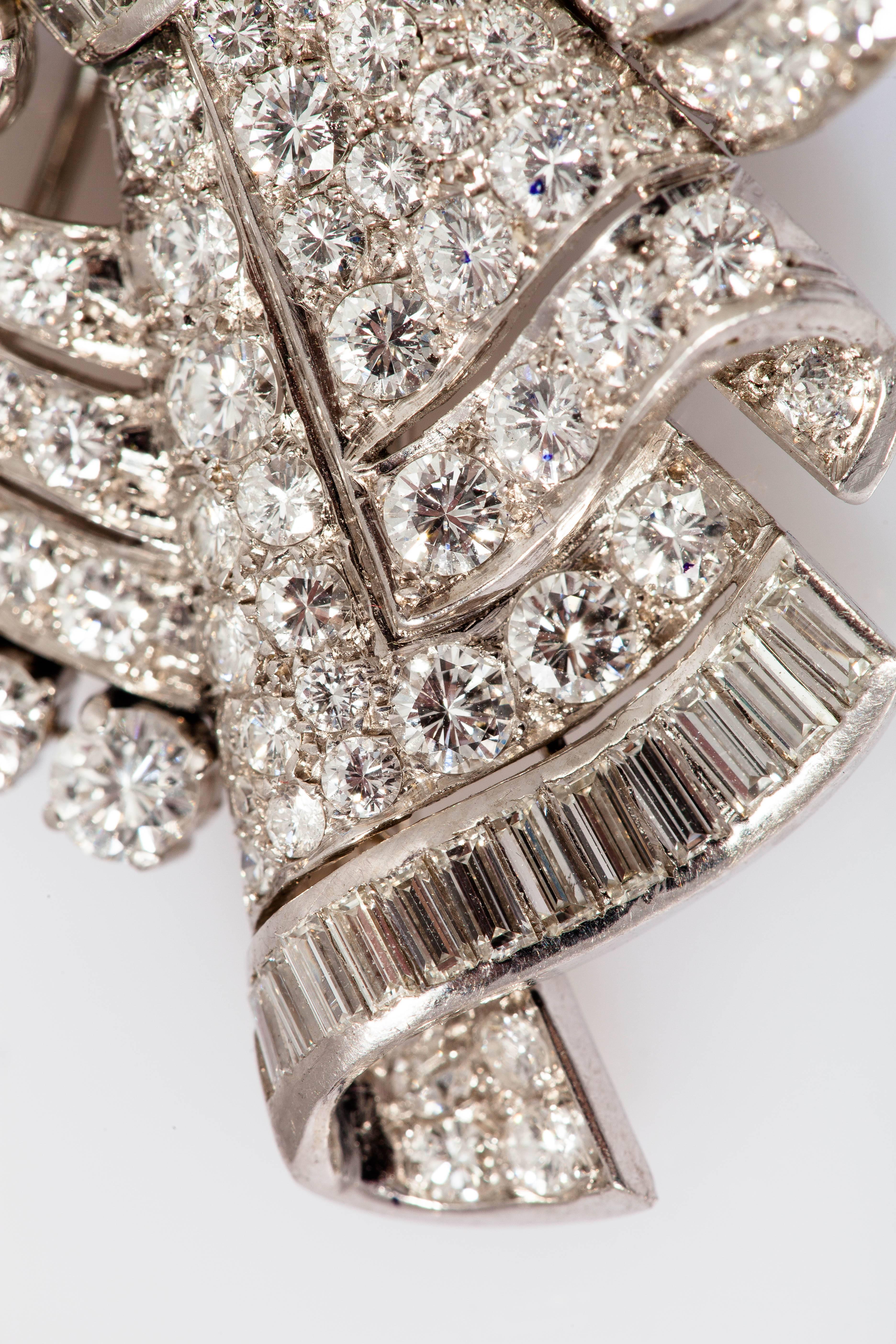 Gorgeous Art Deco double clip finely crafted in platinum with a mix of baguette and round cut diamonds weighing approx. 20.00 carats and two round brilliant cut diamonds weighing 1.00 carats.   