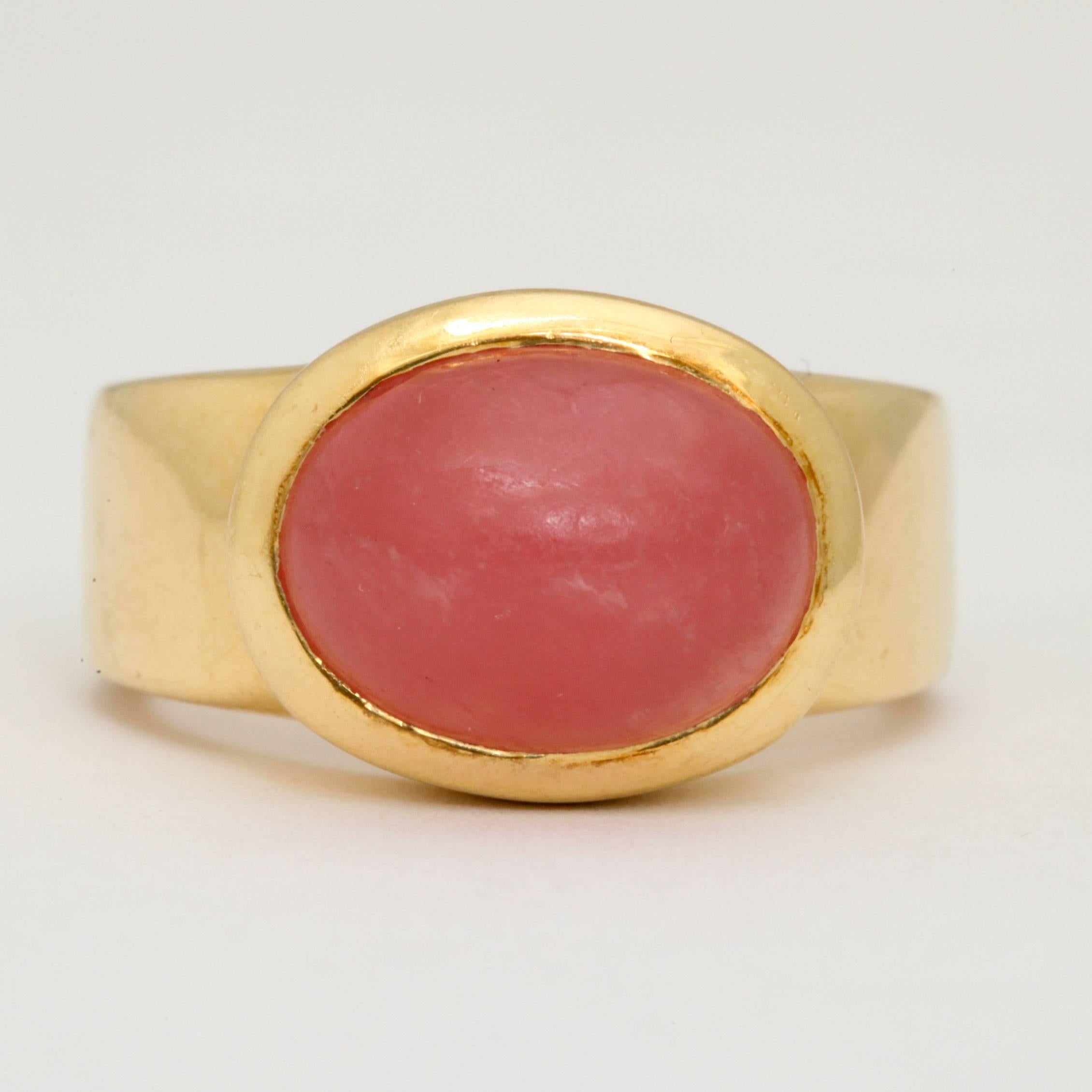 18kt yellow gold unusual hip ring centering a red Rhodochrosite Cabochon stone weighing approximately 7 carats set in a simple 18kt yellow gold Bezel setting. Ring Made By H.Stern In brazil in the 1970's