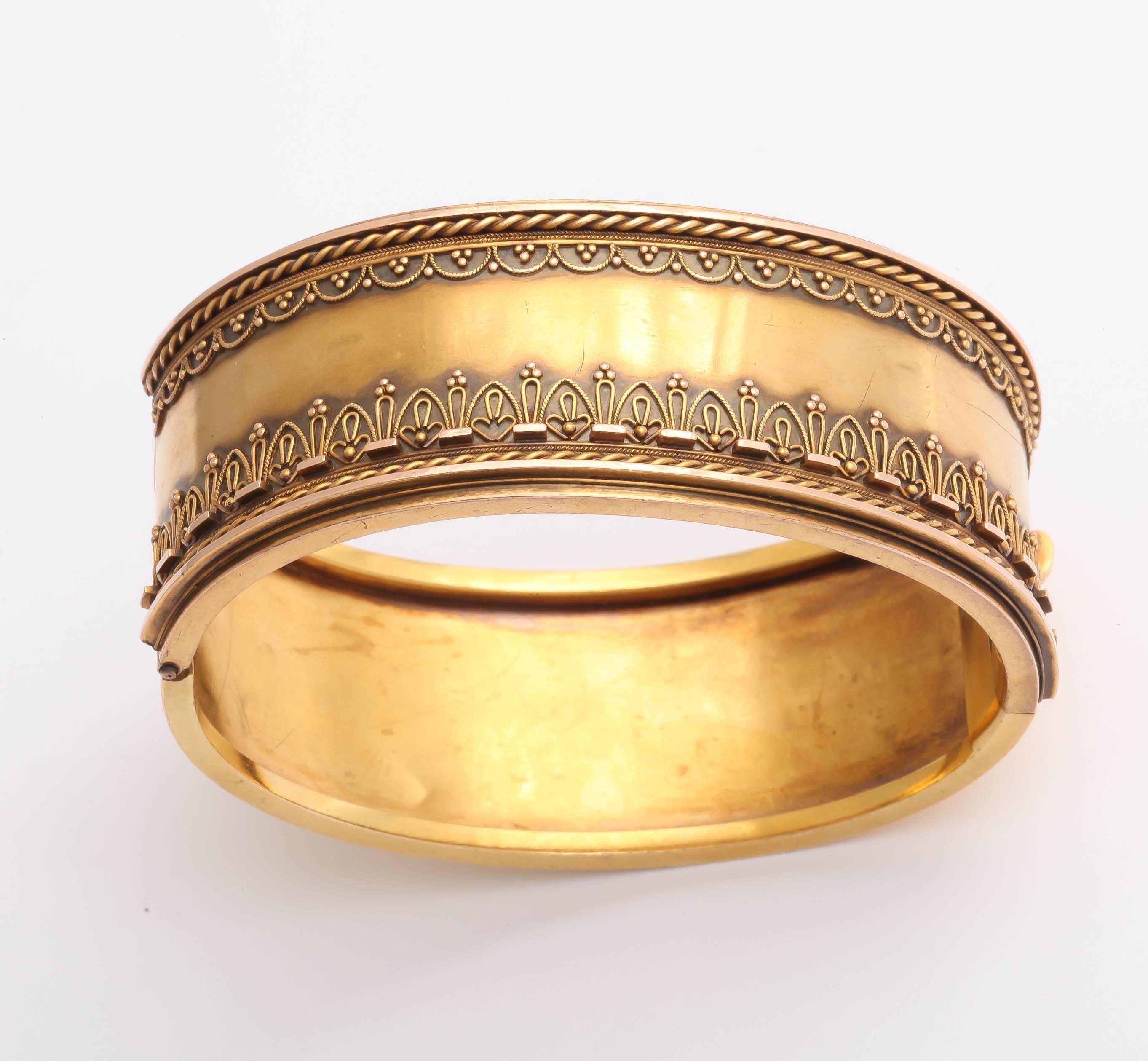 15K English bracelet in the Etruscan Revival style popular during the Victorian era. The front of the bracelet is designed with coiled wires at the top and bottom as well as intricate wire and bead work. An easily wearable, classic Victorian piece. 