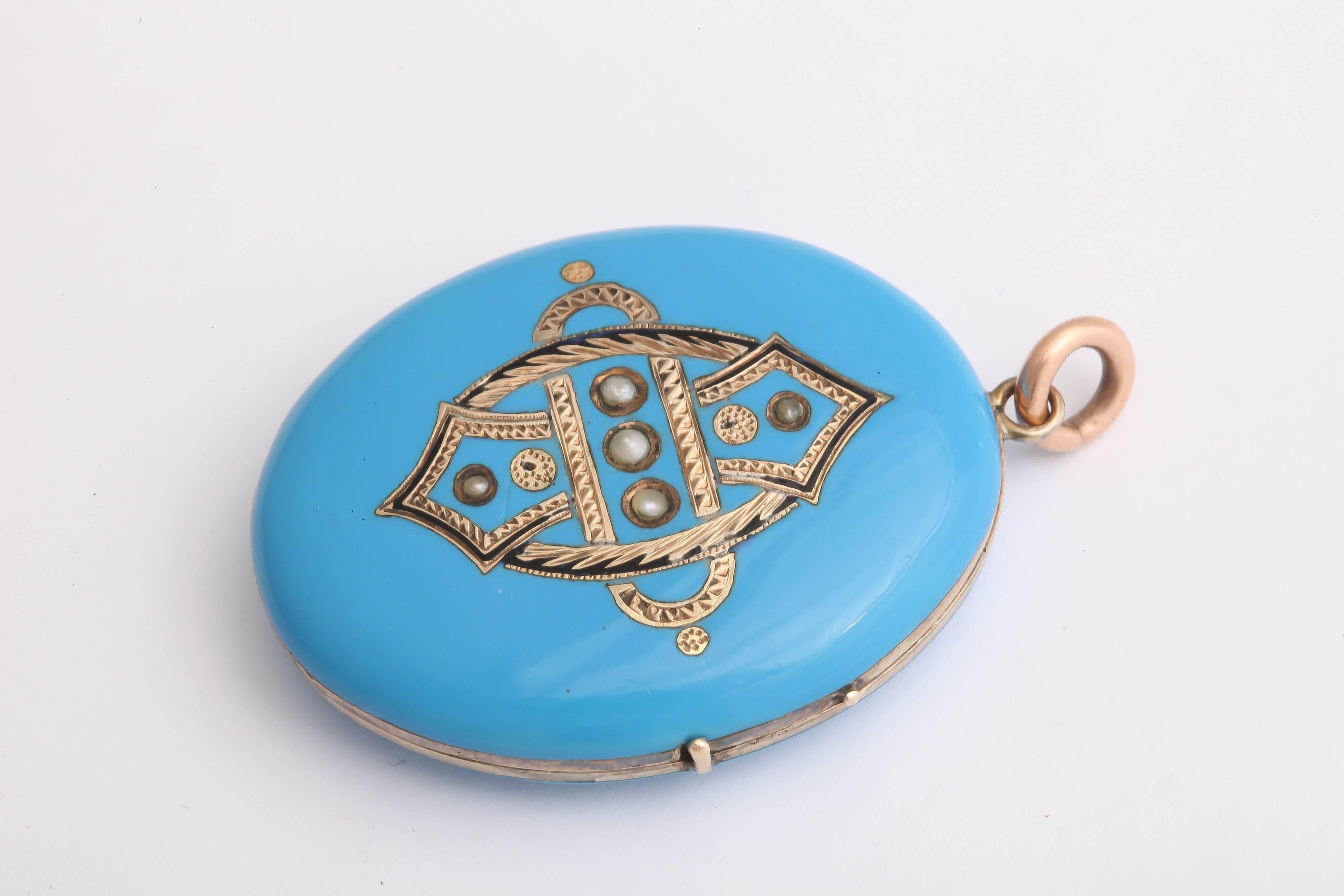 Elegant light blue enameling indicative of the Czech Republic appears on the front and back of this 10K yellow gold locket made in the Victorian era. Black enamel is inaid into the gold engraving on the front and 5 seed pearls  are set into the