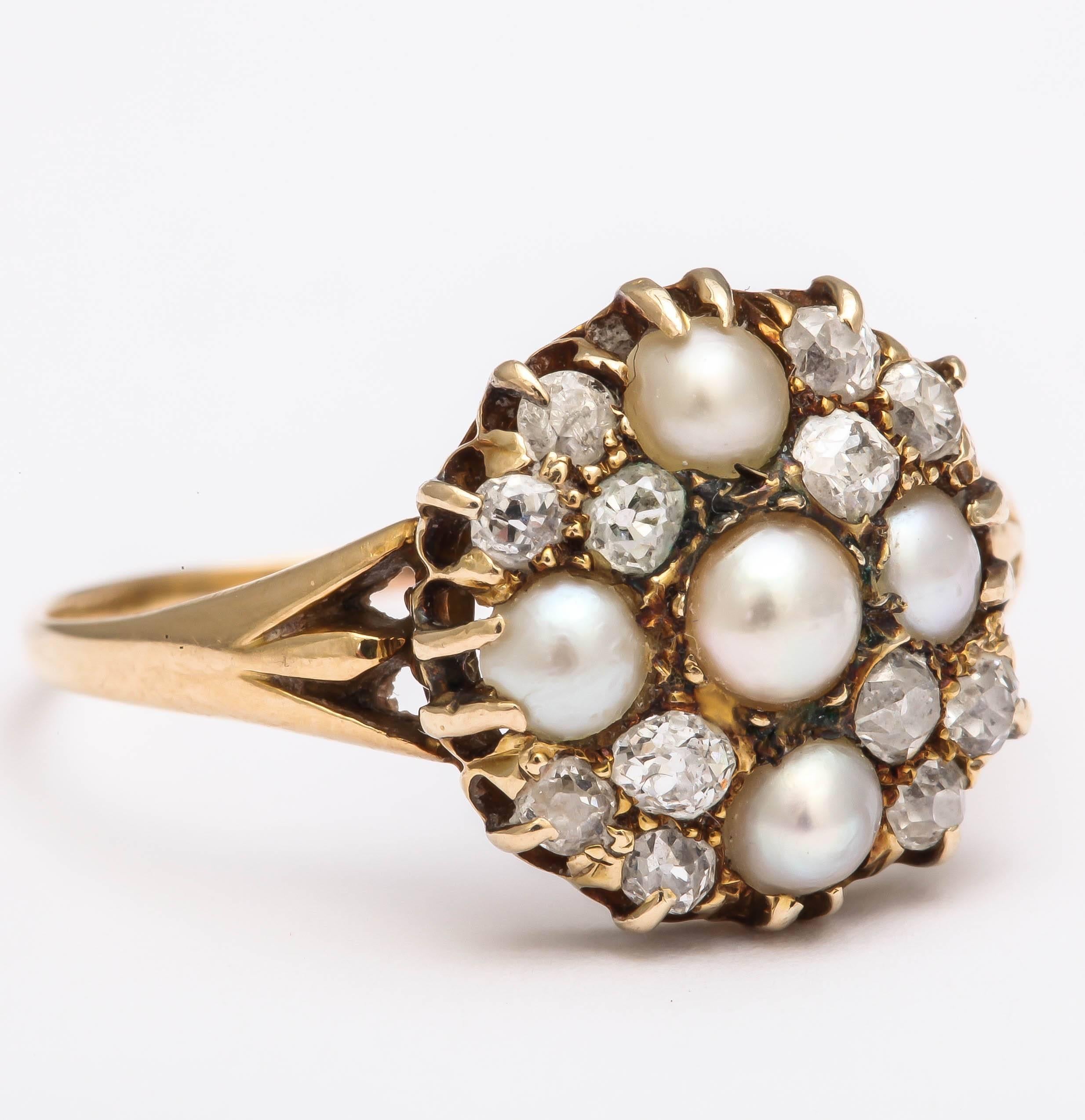 This beautifully designed ring is set with 5 natural pearls in 18K yellow gold. 12 old mine cut diamonds weighing approximately .35cts are set between the pearls. Elegant split shoulder design on either side of the head. Can be sized. 