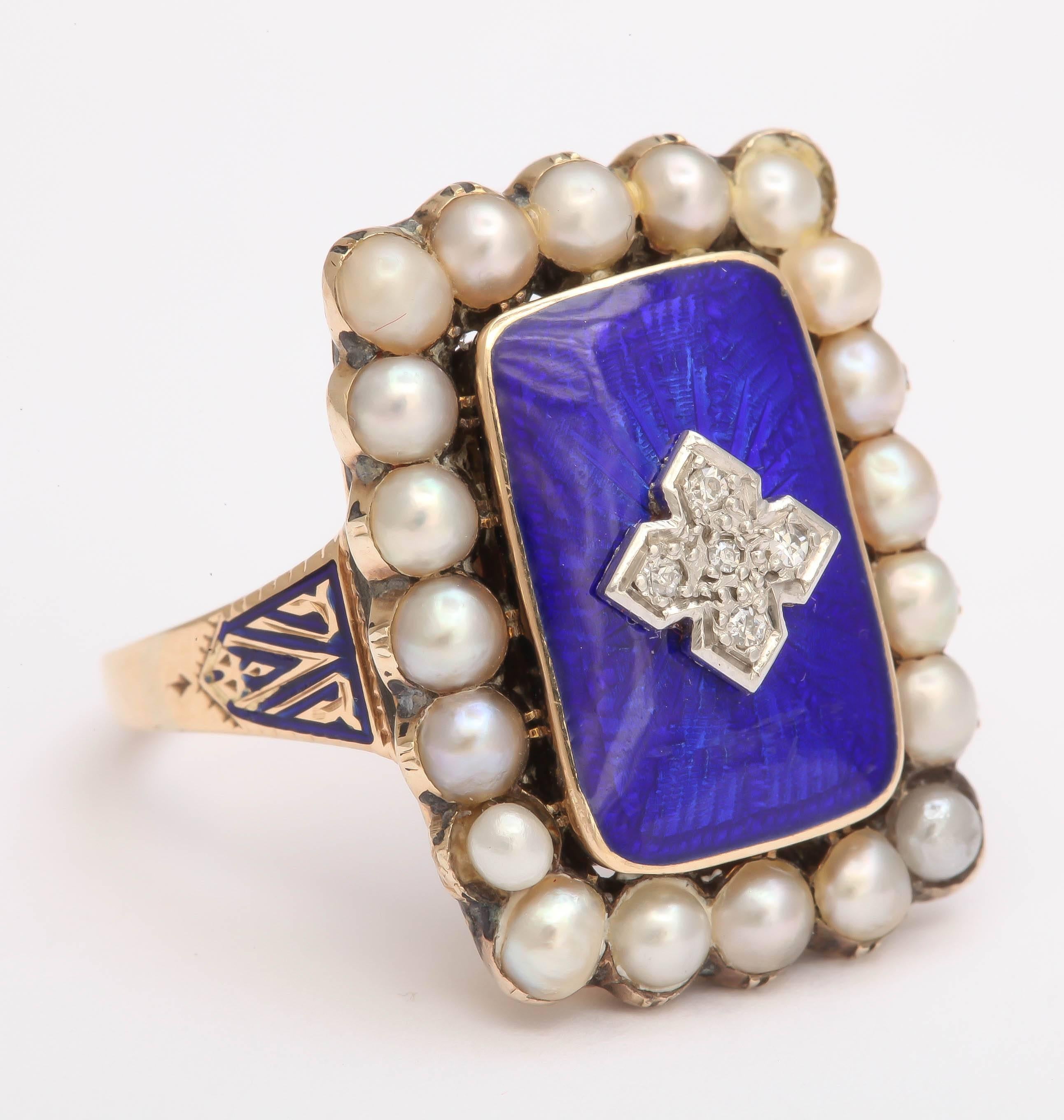 Beyond beautiful! This Georgian ring is blue enameled with a central design set with 5 rose cut diamonds. 20 pearls (most likely natural-but untested) surround the enamel. Shoulders are engraved as well as enameled. 9K yellow gold. Locket beneath