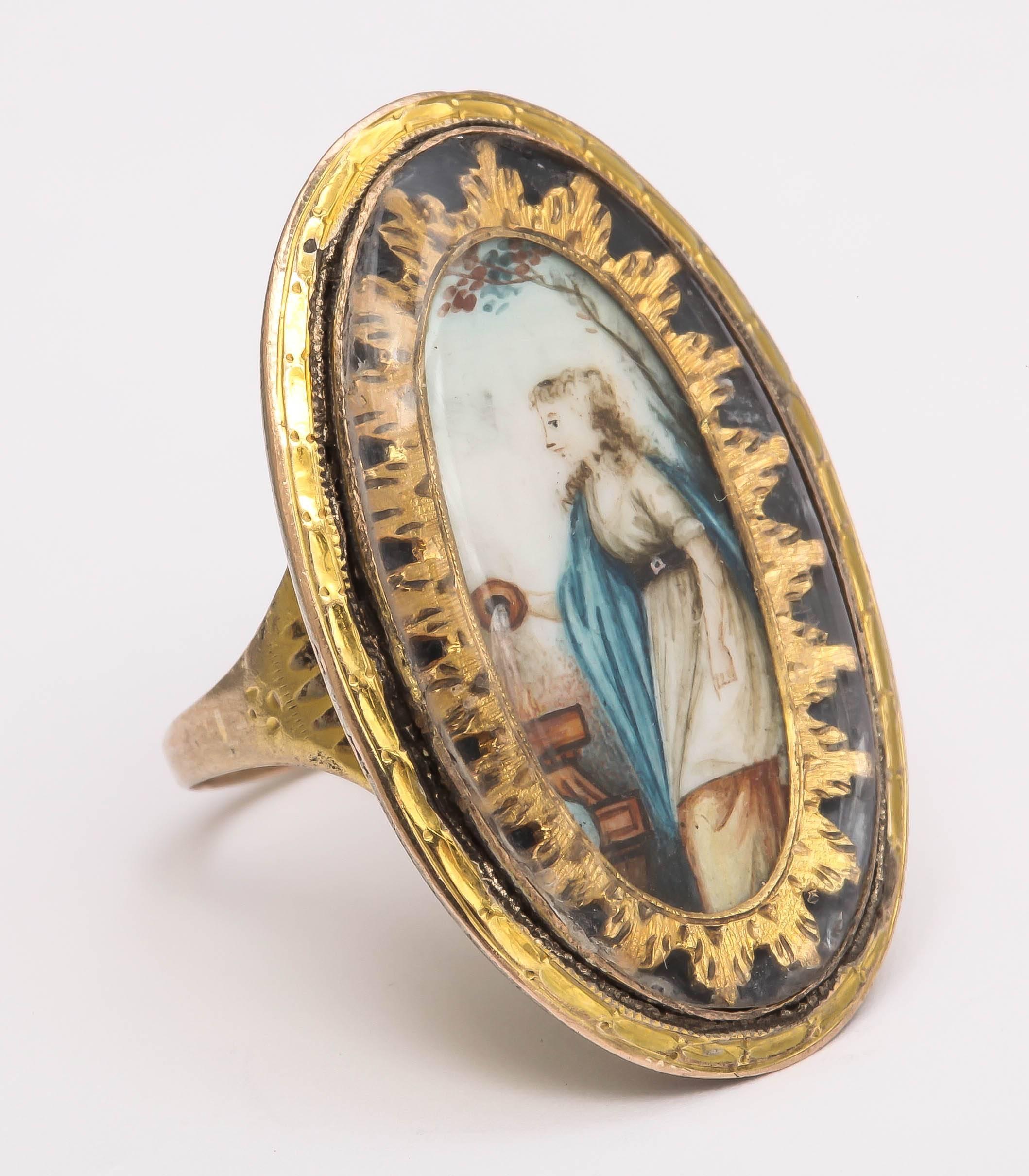 Exquisite mourning ring. Depicts a neoclassical style maiden beneath a tree pouring ashes into an urn. The hand painted miniature is set within a scalloped gold frame under glass. Initials are engraved on the underside of the ring. Shoulders of the