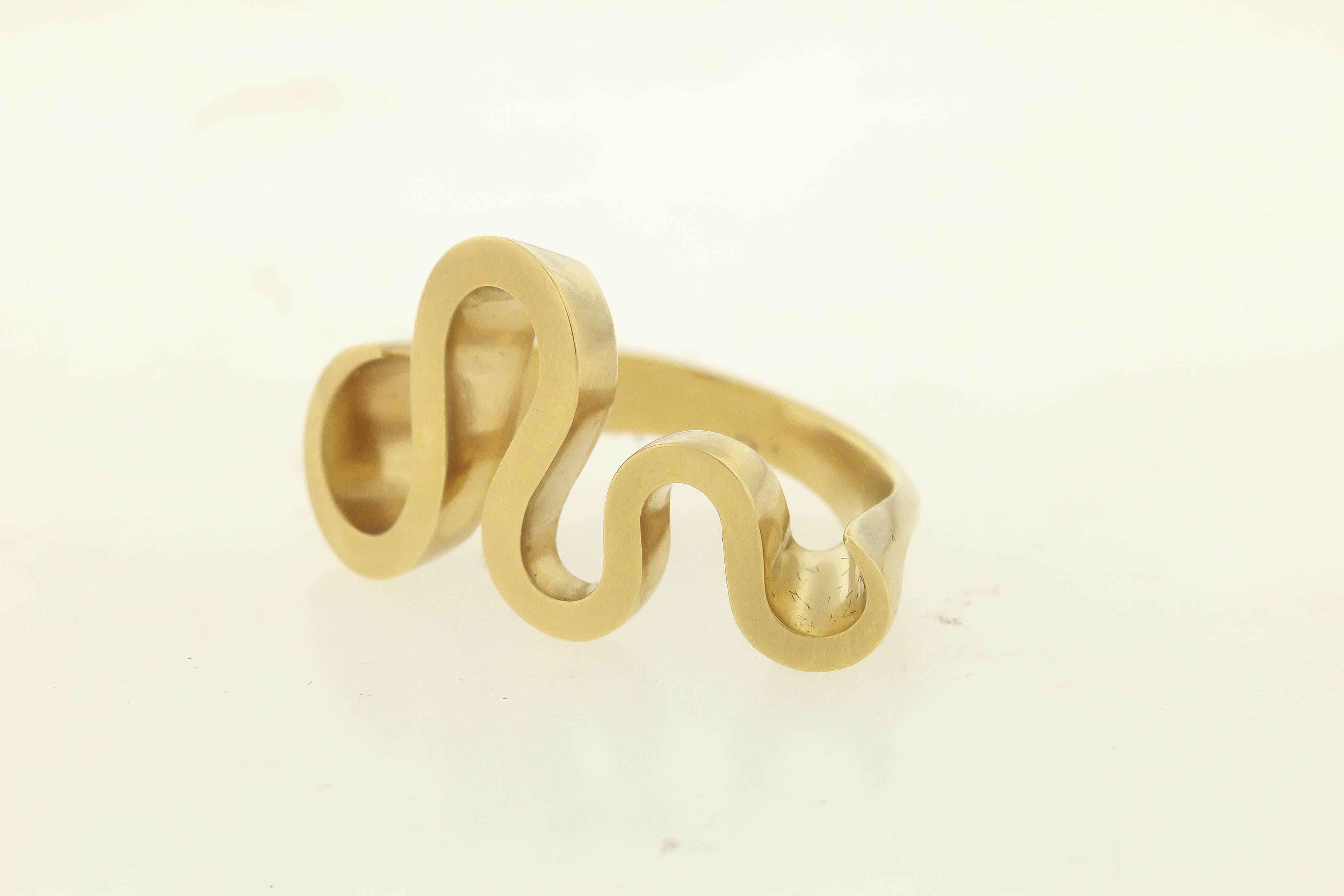 Angela Hubel's abstract Serpenti ring curves over the finger in a voluminous 18K gold sculptural form.  The ring measures 1-1/4