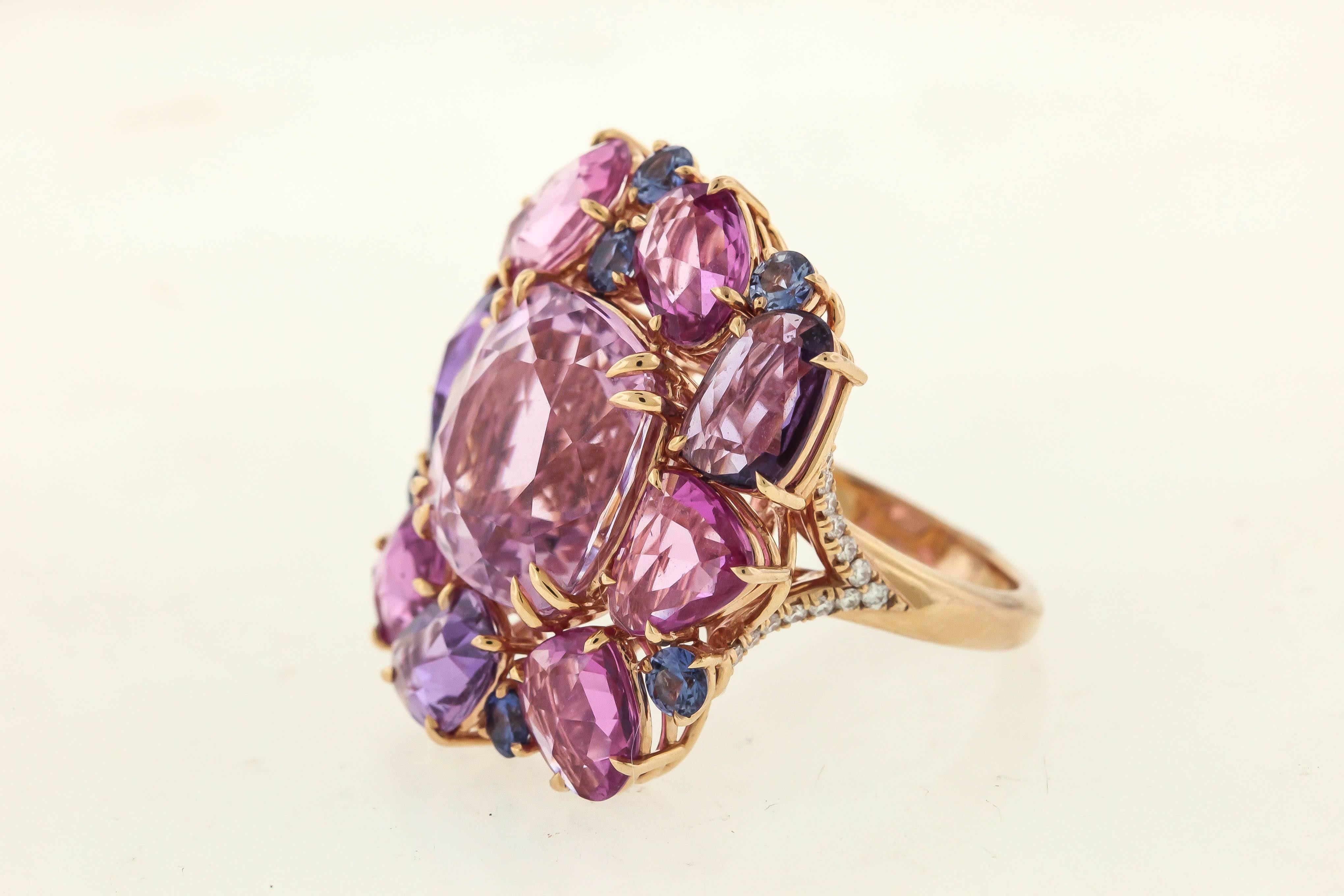 A delicious cocktail ring from Omi Privé, the 12.39 carat pink kunzite surrounded with rose-cut ombré sapphires shading from pink to rose to lavender, accented with blue sapphires, tw sapphires 8.18 cts and 0.19 cts diamonds on the 18K rose gold