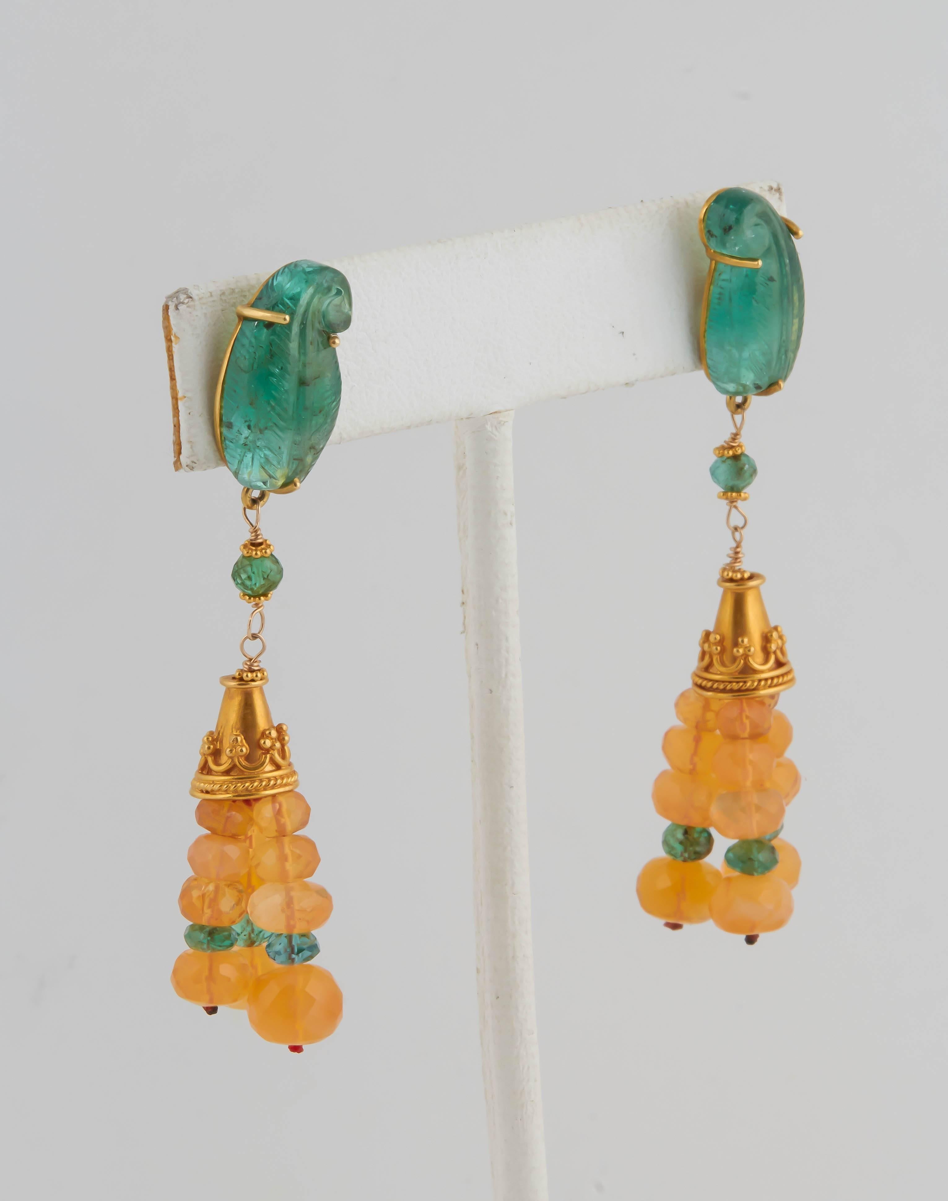 Truly an amazing combination of colored stone beads! All the spacers are 18 kt gold in the earrings and the necklace. The fire opal beads are a clear and striking orange color, a perfect foil for the rich green emerald beads.The emerald leaves on