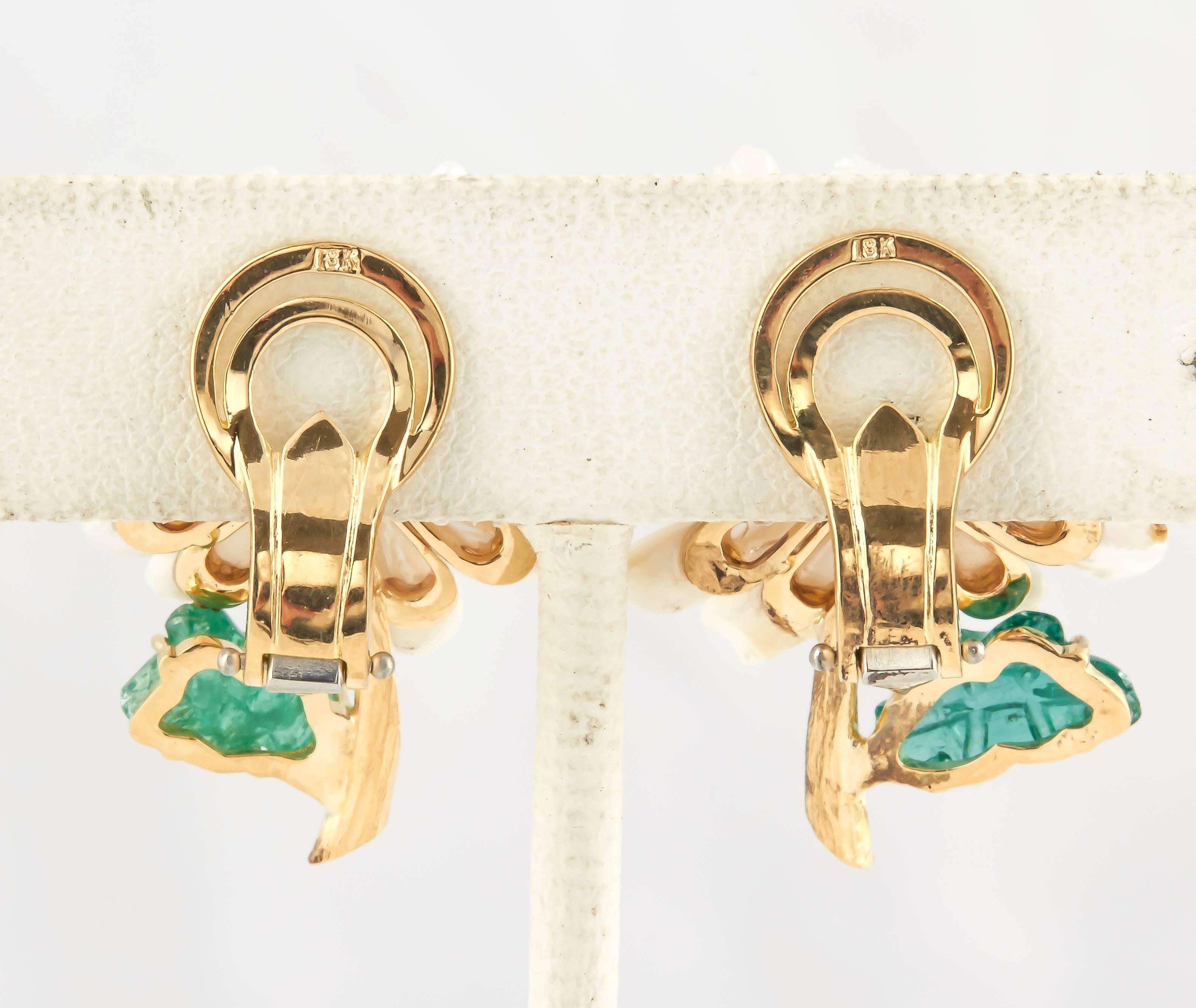 There are 24 Mississippi pearls, shaped like daisy petals , emerald leaves, with an opal center surrounded with bezel set diamonds and gold stamen surrounding the opal. These are clip earring but a post can be added. Truly beautiful and unique also