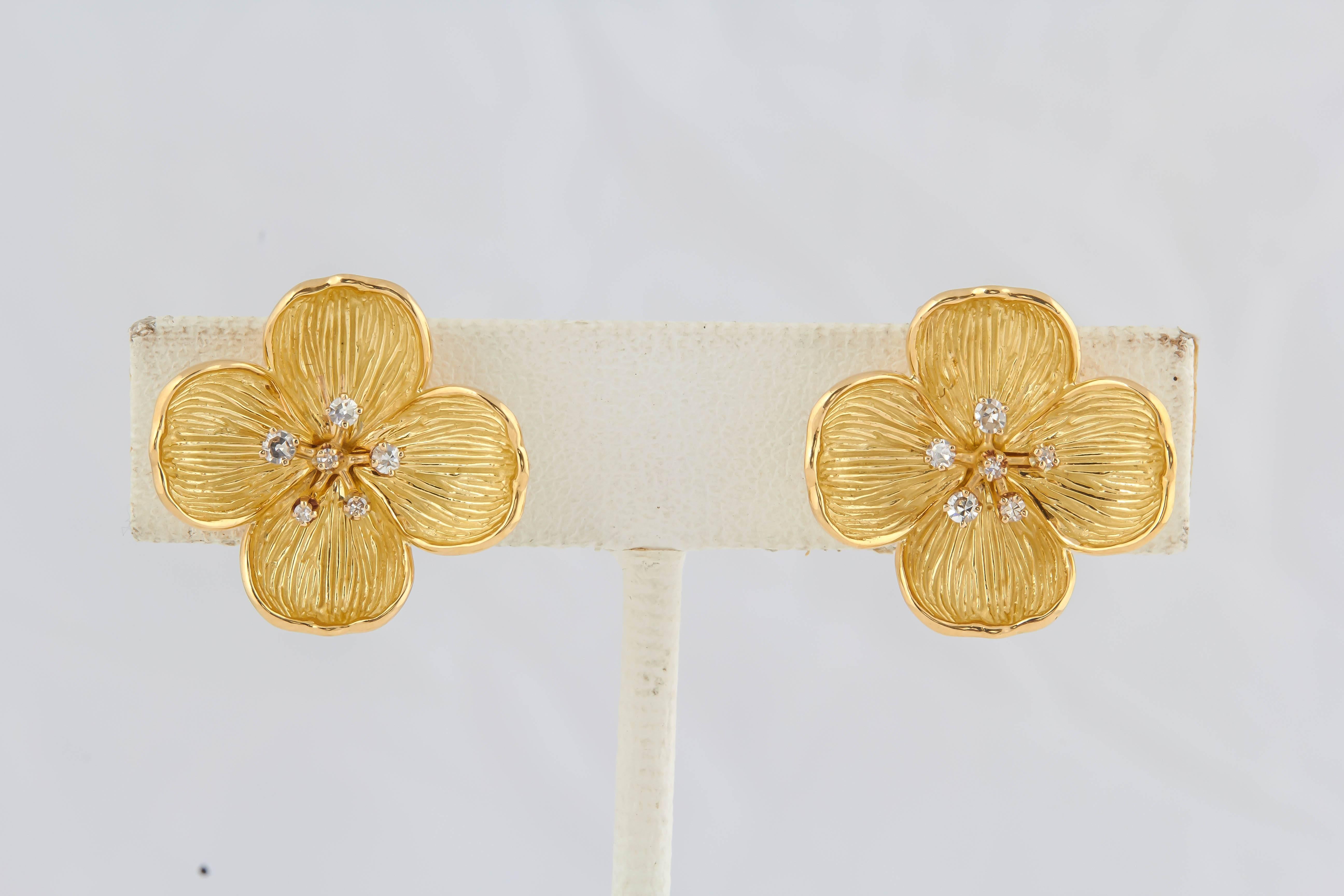 These Tiffany-style dogwood flowers are beautiful on the ear. The petals are delicately  engraved for natural texture and the center is a spray of diamonds These are clip earrings for a post can be added..