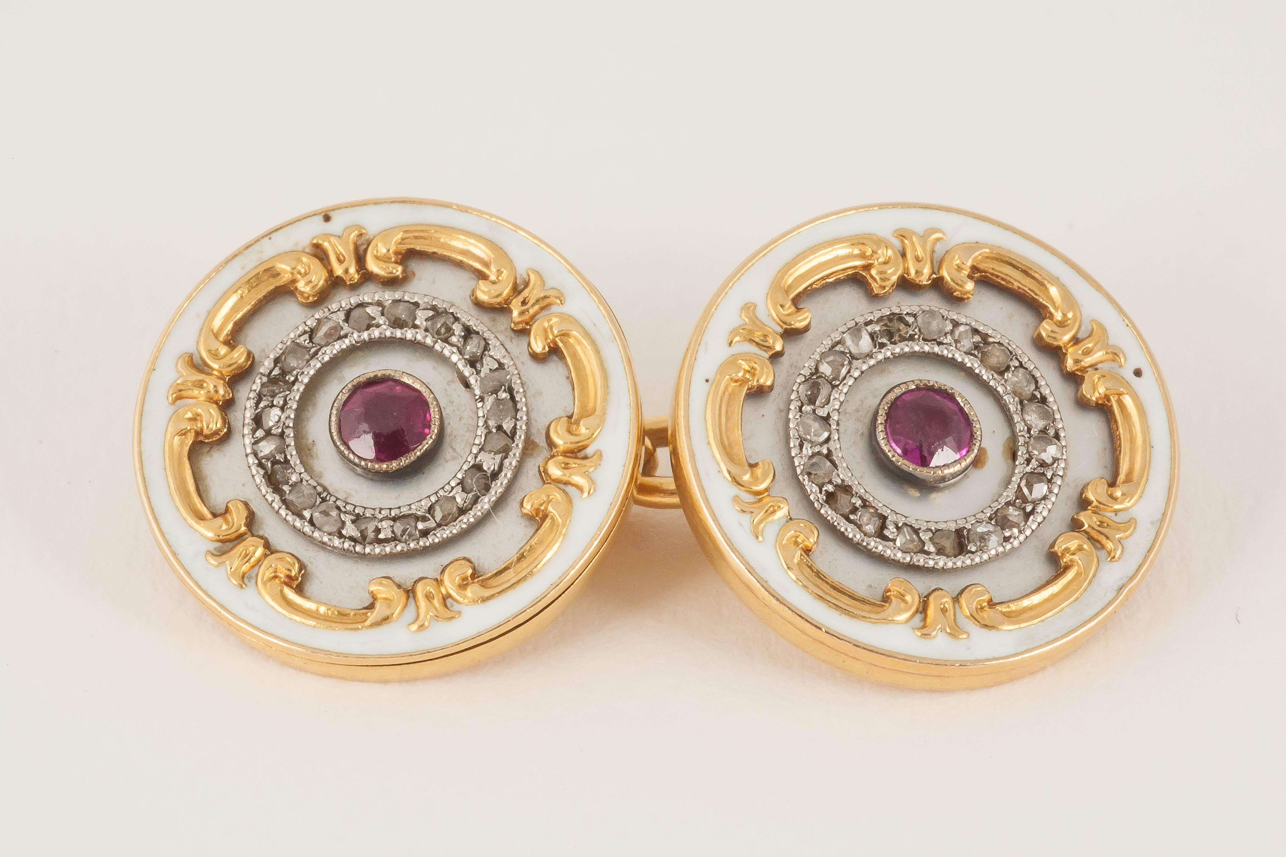 Pair of attractive Art Nouveau 18ct [stamped] yellow gold cufflinks with centre Burma ruby on a mother of pearl background  with rose cut diamonds,gold scrolls and a white enamel border.English c 1900