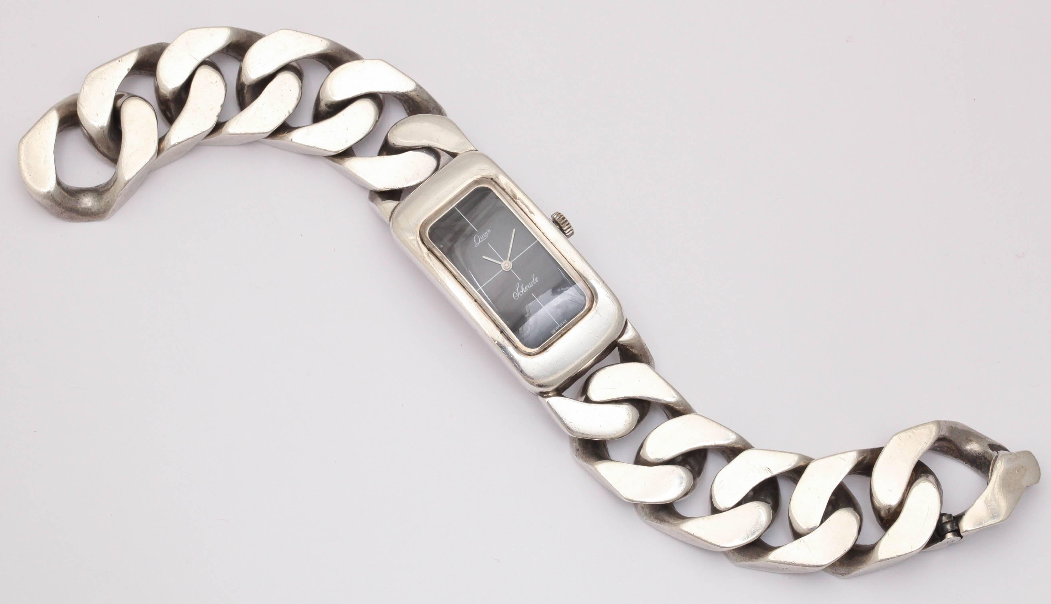 Over the top - black Faced Watch with Heavy silver Bracelet Link.  Sterling Silver Wind up.  Conforms to the wrist.  Very luxe.  Made in Germany.
