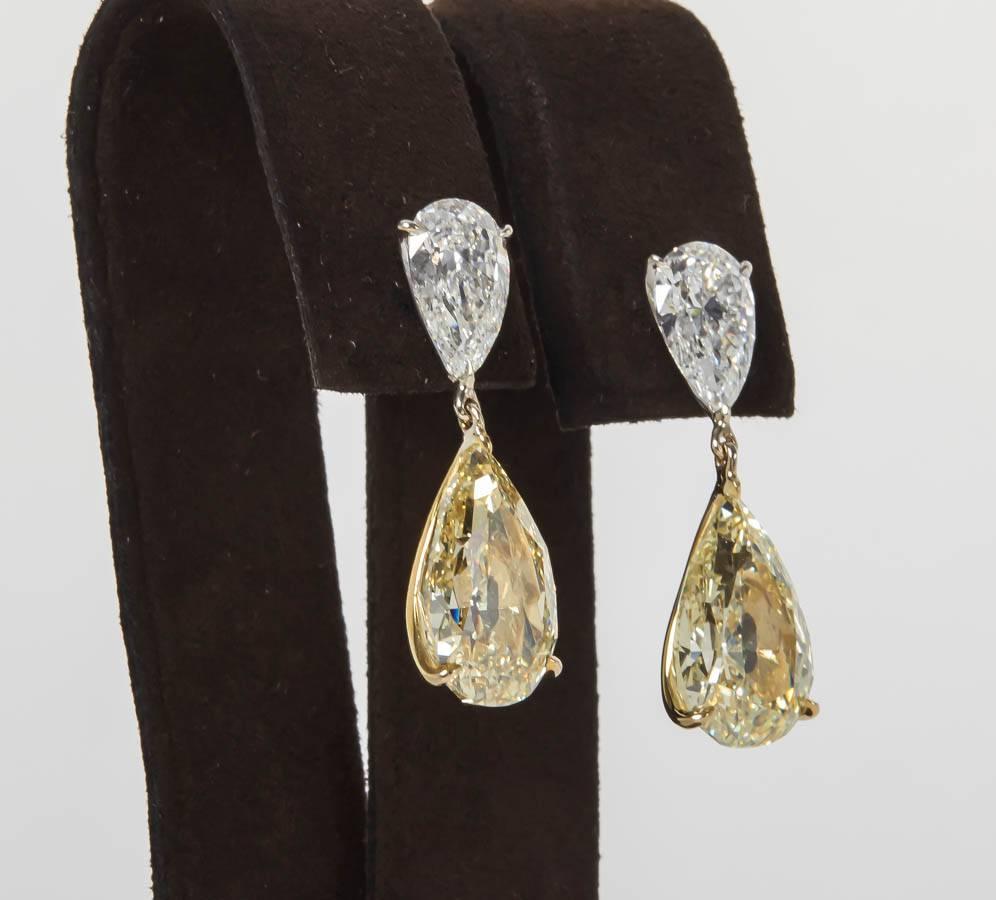 

A remarkable pair of yellow and white diamond earrings.

Four brilliant and beautifully cut diamonds each certified by GIA -- a total of 14.07 carats set in handmade 18k white and yellow gold custom designed mountings.

The white diamonds