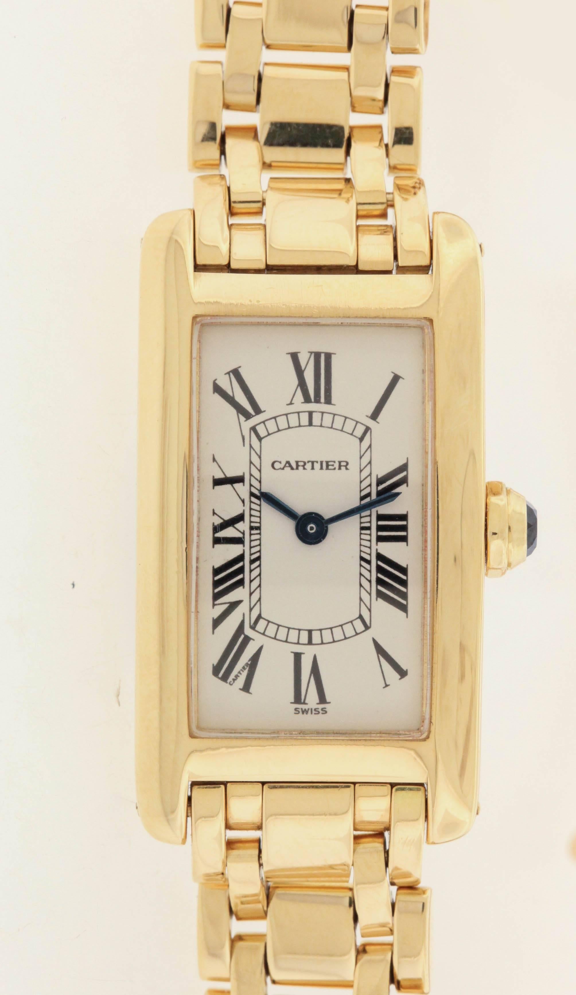 18K yellow gold Cartier Tank Americaine, Ref. 1710, made in the 1990's, is a  curved-rectangular, water-resistant, 18K yellow gold women's quartz wristwatch on an 18K yellow gold Cartier link bracelet with concealed double-folding clasp.  The 19mm x