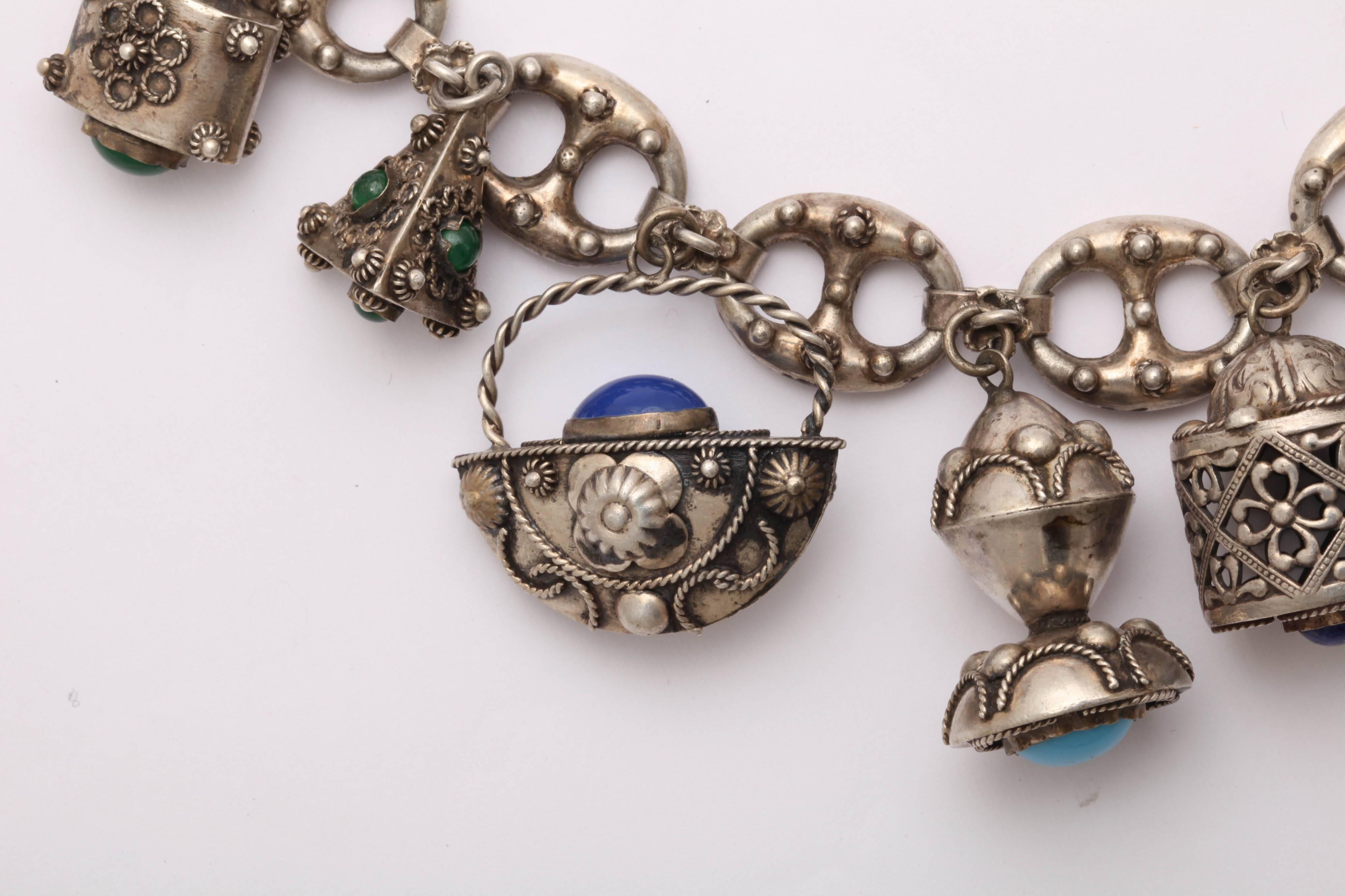 Lighthearted pleasure and sheer fun is packaged for you with the arrival of this chunky eight charm bracelet of silver and cabochon glass stones. I wore it this week to test how it makes me feel. It is more loved now than ever. It is a beautiful and
