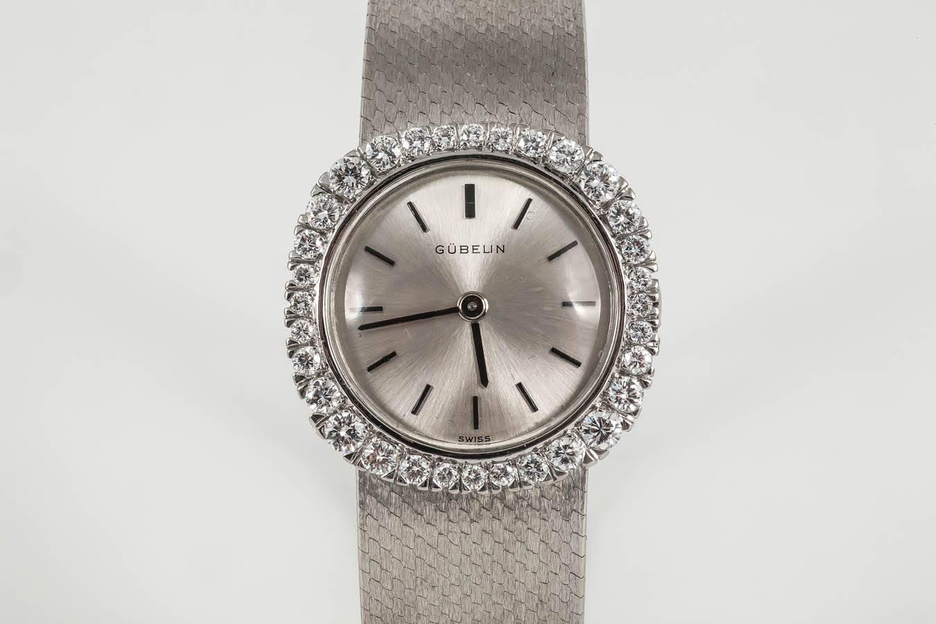 A finely made 18kt white gold ladies evening watch by Gubelin,with graduating,8 cut diamonds surrounding,Swiss c,1950,with mechanical movement