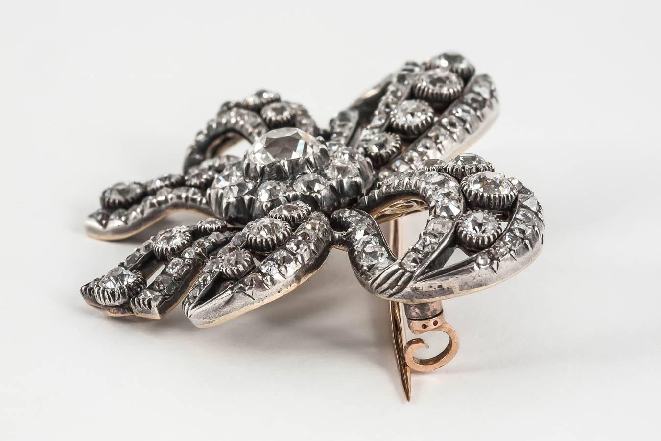 A finely made,French brooch in the form of a double tied Bow,set throughout with old cut diamonds,mounted in silver and gold.c.1880.Approximately 12-13 carats