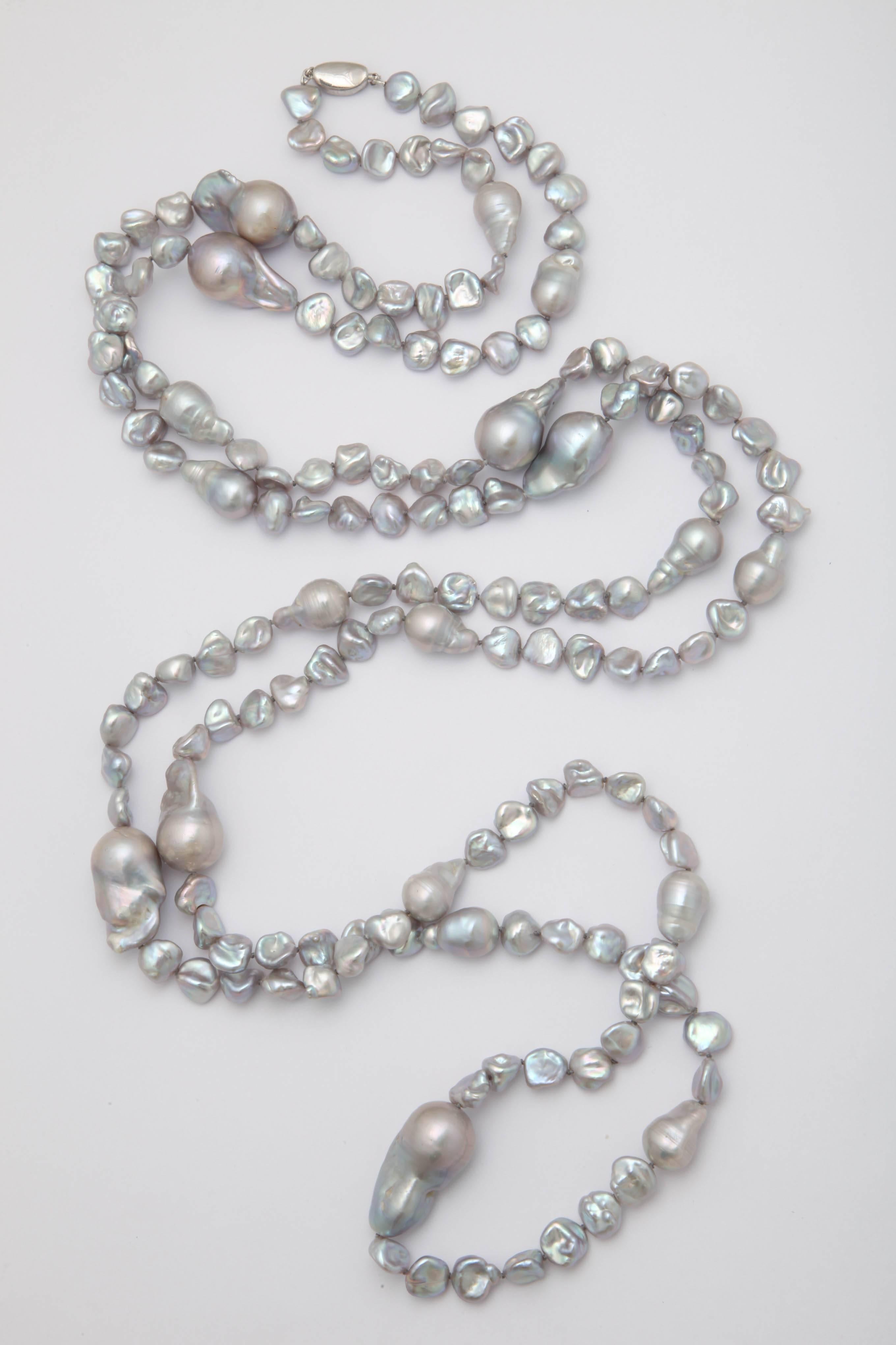 Large grey fresh water baroque pearls, average length 1 1/4 in. ,interspersed  with  3/8 to 1/2 in keshi grey fresh water pearls to create a magnificent necklace 70 in. long with a sterling silver clasp. This necklace can be worn in many way and can